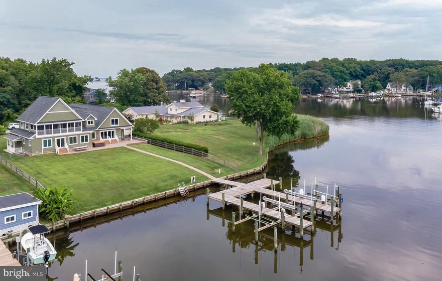 It's all about the water, the views, and the lifestyle! Stunning, unobstructed water views of Wharf creek AND private double pier with electric and water will accommodate 4+ boats with 8 ft. MLW.  Featuring (3) automatic boat lifts (20K/15K/8K) and 100’ of water frontage. This home also includes a waterside pavered patio, spacious 2nd level screened in porch, a dream (4) car-attached heated 1700 SQ. FT.  garage,  and plenty of yard for summer activities & volleyball!  The Open floor plan takes advantage of the views from almost every room. Custom rebuilt in 2011 with the primary suite on the main floor and all the upgrades you would expect! Beautiful Hardwood floors, high ceilings, solid wood doors, Anderson UV Tinted Windows and Sliders, heated tile flooring,  foam insulation enhancing the 3 zones for heating and cooling, Generac whole house generator, architectural roof, granite counters, stainless steel appliances, recessed lighting, fireplace, and more. Move right in! The home features 4-5 Bedrooms / 5 Bathrooms, multiple living spaces, second-floor entertainment room with wet bar, full bathroom and opens to a large screened porch overlooking the water. Large finished basement features a TV/Entertainment space, BR, BA, and 2nd laundry room and storage closet. This home has it all! Enjoy the waterfront lifestyle and everything that this incredible property has to offer!