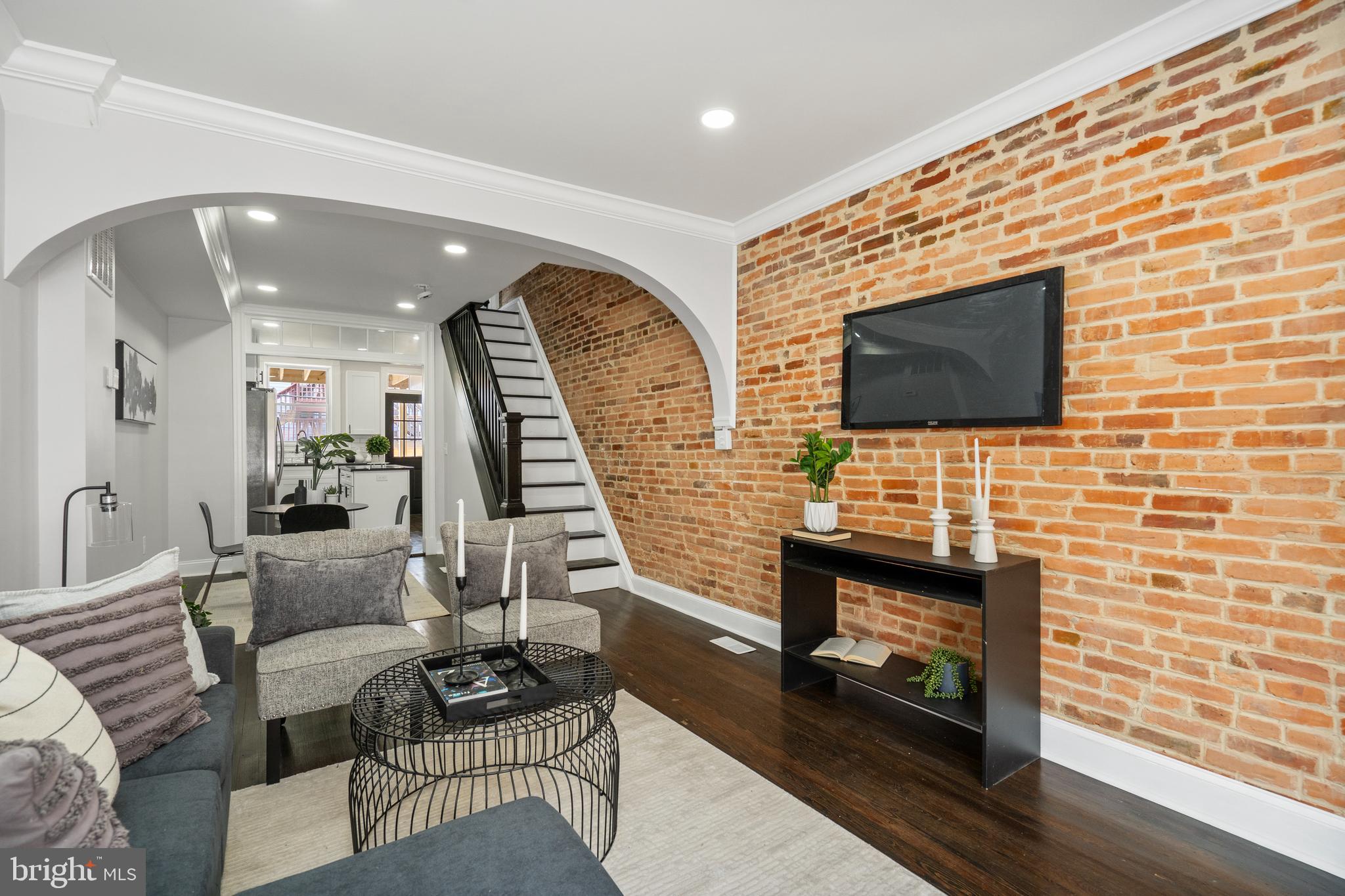 Stunning CHAP Renovation in the Heart of Canton! This fully renovated gem offers the perfect blend of charm, functionality, and location—complete with 10-Year CHAP Tax Credit approval saving you about $650 per month! Step inside to beautifully refinished hardwood floors that flow throughout a bright and open floor plan. The spacious living room is ideal for entertaining, while the adjoining dining area opens seamlessly to a chef's kitchen featuring quartz countertops, stainless steel appliances, a tile backsplash, ample cabinetry, and a center island for casual dining. Upstairs, the spacious primary suite is a true retreat with dual closets and a luxurious ensuite bath boasting double vanities and a large walk-in shower. A second bedroom and full bath with a tub/shower combo complete the level, along with access to both a second-story deck and a rooftop deck showcasing panoramic views of Patterson Park, the iconic Natty Boh Tower, the Inner Harbor, and Downtown Baltimore. The fully finished lower level offers two additional bedrooms, a full bath, laundry area, and extra storage—plus direct access from the rear private parking pad for added privacy and convenience. Just 3 blocks to Patterson Park and Canton Square, and moments from Canton Crossing and all the vibrant shops and restaurants the neighborhood is known for. Don’t miss your chance to own this thoughtfully renovated home in one of Baltimore’s most sought-after neighborhoods!