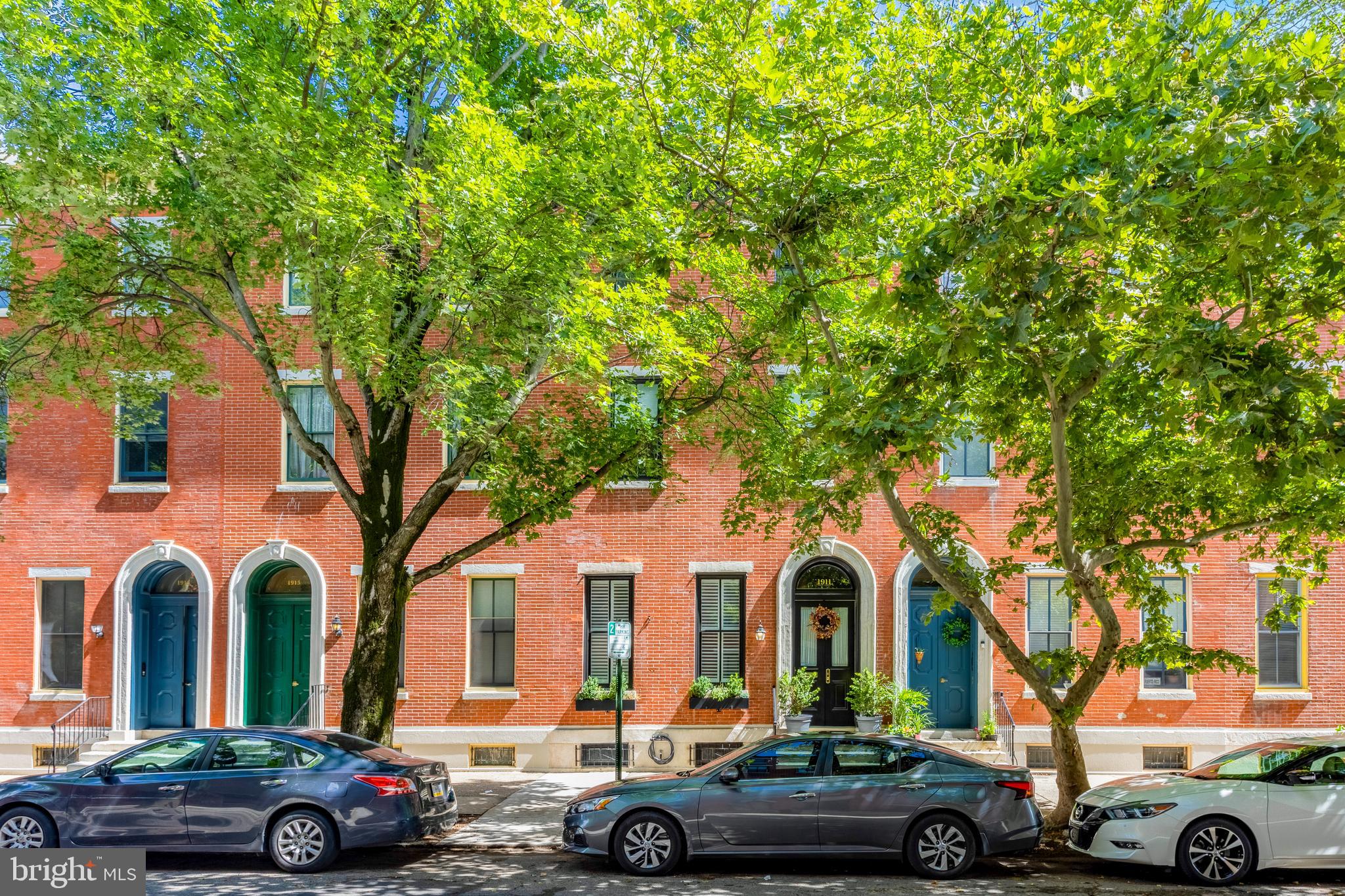 Nestled in the heart of the sought-after Fairmount neighborhood, this quintessential brick row home at 1911 Mt Vernon Street seamlessly blends timeless historic character with thoughtful modern upgrades. Situated just off of 19th & Mt Vernon, the home offers expansive, flexible living across multiple levels—perfect for today’s dynamic lifestyle.
Step into the elegant living room, where soaring ceilings, intricate plaster crown molding, and original millwork reflect the beauty of pre-Civil War architecture. A custom walnut bookcase provides ample built-in storage, while the room’s generous proportions allow for multiple layout options.
The updated kitchen is a true chef’s haven, featuring maple cabinetry, stainless steel appliances, Jerusalem Stone countertops, and a suite of high-end amenities: built-in wall oven, warming drawer, gas cooktop with vent hood, and abundant storage. Details like a floor-to-ceiling bookcase and a china cabinet facing the dining room add both charm and functionality. Recessed, pendant, and under-counter lighting ensure a well-lit, inviting space for all culinary endeavors.
Just off the kitchen, the spacious dining room is anchored by an elegant marble mantle and exposed brick walls—adding warmth and character. Glass doors open to a private outdoor retreat complete with a newly installed composite deck and raised garden beds—ideal for entertaining, dining al fresco, or enjoying a peaceful gardening moment. A recently renovated half bath with designer tile and premium fixtures is smartly tucked under the staircase.
Upstairs, the luxurious primary suite easily accommodates a king-sized bed and features a fireplace with Victorian tile surround and a carved wooden mantle. A brand-new ensuite bathroom boasts double sinks with Calcutta marble countertops, heated floors, and a custom closet system. Just a half-flight up, you’ll find another beautifully renovated full bathroom with a freestanding tub, fully tiled stand-up shower, and dedicated laundry space—also outfitted with Calcutta marble and radiant heat flooring. An adjacent bedroom offers flexible use as a home office, playroom, or cozy den.
Continuing up, another half-flight opens to a spacious common area, a third full bathroom, and an additional bedroom. The top floor features two more bedrooms, perfect for guests or growing households. Throughout the upper levels, historic hardwood floors and high ceilings evoke a sense of grandeur, while the home’s unique multi-level layout provides both privacy and flexibility.
Recent upgrades include newly installed sewer and water lines from the house to the street, as well as updated electrical systems for the renovated bathrooms.
Ideally situated just blocks from Fairmount Avenue's shops and restaurants, Spring Garden community plots, Roberto Clemente Park, and the top-ranked Julia R. Masterman School, this home also offers easy access to public transit and some of Philadelphia’s most iconic cultural institutions—including the Art Museum, Franklin Institute, Rodin Museum, and Barnes Foundation.
1911 Mt Vernon Street offers the best of city living—historic beauty, modern comfort, and an unbeatable location.