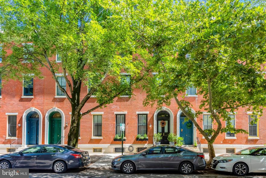 Nestled in the heart of the sought-after Fairmount neighborhood, this quintessential brick row home at 1911 Mt Vernon Street seamlessly blends timeless historic character with thoughtful modern upgrades. Situated just off of 19th & Mt Vernon, the home offers expansive, flexible living across multiple levels—perfect for today’s dynamic lifestyle.

Step into the elegant living room, where soaring ceilings, intricate plaster crown molding, and original millwork reflect the beauty of pre-Civil War architecture. A custom walnut bookcase provides ample built-in storage, while the room’s generous proportions allow for multiple layout options.

The updated kitchen is a true chef’s haven, featuring maple cabinetry, stainless steel appliances, Jerusalem Stone countertops, and a suite of high-end amenities: built-in wall oven, warming drawer, gas cooktop with vent hood, and abundant storage. Details like a floor-to-ceiling bookcase and a china cabinet facing the dining room add both charm and functionality. Recessed, pendant, and under-counter lighting ensure a well-lit, inviting space for all culinary endeavors.

Just off the kitchen, the spacious dining room is anchored by an elegant marble mantle and exposed brick walls—adding warmth and character. Glass doors open to a private outdoor retreat complete with a newly installed composite deck and raised garden beds—ideal for entertaining, dining al fresco, or enjoying a peaceful gardening moment. A recently renovated half bath with designer tile and premium fixtures is smartly tucked under the staircase.

Upstairs, the luxurious primary suite easily accommodates a king-sized bed and features a fireplace with Victorian tile surround and a carved wooden mantle. A brand-new ensuite bathroom boasts double sinks with Calcutta marble countertops, heated floors, and a custom closet system. Just a half-flight up, you’ll find another beautifully renovated full bathroom with a freestanding tub, fully tiled stand-up shower, and dedicated laundry space—also outfitted with Calcutta marble and radiant heat flooring. An adjacent bedroom offers flexible use as a home office, playroom, or cozy den.

Continuing up, another half-flight opens to a spacious common area, a third full bathroom, and an additional bedroom. The top floor features two more bedrooms, perfect for guests or growing households. Throughout the upper levels, historic hardwood floors and high ceilings evoke a sense of grandeur, while the home’s unique multi-level layout provides both privacy and flexibility.

Recent upgrades include newly installed sewer and water lines from the house to the street, as well as updated electrical systems for the renovated bathrooms.

Ideally situated just blocks from Fairmount Avenue's shops and restaurants, Spring Garden community plots, Roberto Clemente Park, and the top-ranked Julia R. Masterman School, this home also offers easy access to public transit and some of Philadelphia’s most iconic cultural institutions—including the Art Museum, Franklin Institute, Rodin Museum, and Barnes Foundation.

1911 Mt Vernon Street offers the best of city living—historic beauty, modern comfort, and an unbeatable location.