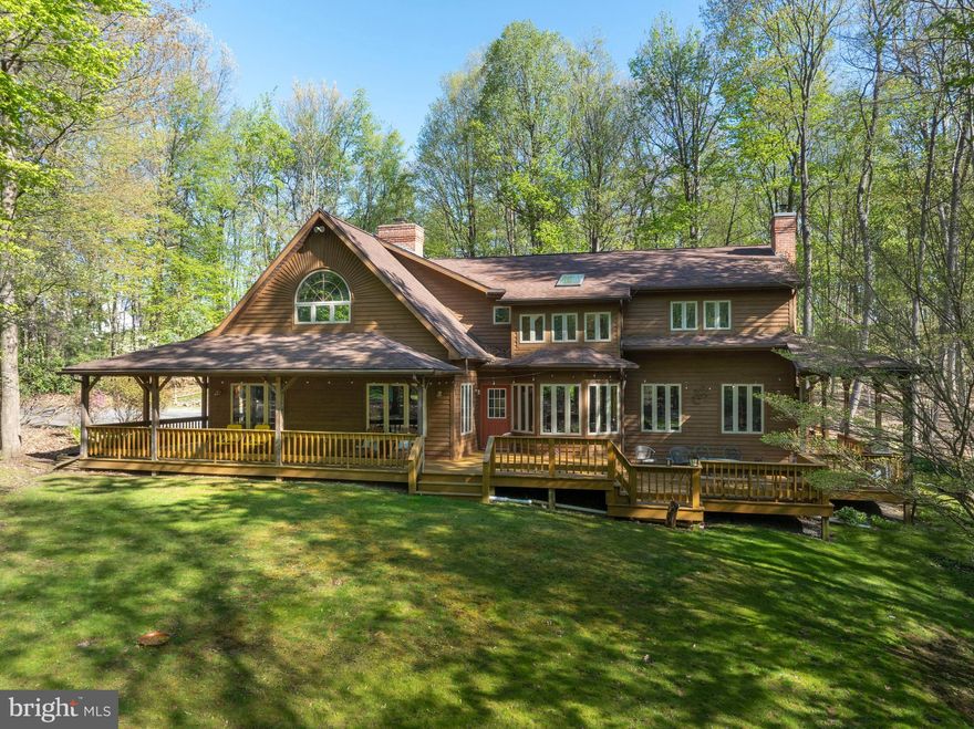 Wooded wonderland minutes from downtown State College and Penn State's Campus!  This highly secluded, solid custom-built home rests on 10 private acres and is in Clean & Green, reducing the real estate taxes.  Be greeted by a welcoming wrap around front porch and enter into the spacious great room, which boasts tongue & groove wood cathedral ceilings, a brick wood-burning fireplace, wood floors, French doors, and an abundance of natural light.  Enjoy entertaining in the ample sized kitchen with its granite countertops, stainless steel induction range, and beamed ceiling, in the dining room with custom, high-quality built-in hutch, and in the large nook with access to the deck for cook-outs and alfresco dining.  Relax in the sunken family room that features wood flooring, a tongue & groove and beamed ceiling,  a new wood stove, and access to the covered porch, or get to work in the large front workout/office area.  Retreat to the second floor's spacious primary suite, which boasts a vaulted ceiling, an outdoor balcony, a large walk-in closet with built-ins, and a remodeled spa-like ensuite bath with a custom vanity, tiled walk-in shower, heated towel bars, tankless water heater, and a soaking tub.  Three ample sized bedrooms, a loft area,  and a large hall bathroom with a double vanity, many windows, a skylight, and it's own jetted tub complete the top floor.  There's ample storage in the attic, unfinished basement, and in the detached three car garage complete with an additional storage level.  You'll appreciate the economical heating and cooling bills with the geothermal HVAC system.  Relax under the covered porch and on the sprawling decks, taking in the beauty of the woods and wildlife surrounding you.  Other features include six panel solid wood doors, radon mitigation, a water softener, pre-plumbing in the basement for a future bath, a fenced garden space with potting shed access and plentiful flowering trees and plantings.  If you're looking for a peaceful spot within a short distance of outdoor recreation, shopping, restaurants, downtown State College, Penn State's campus, and access to I-99, this is the property for you!!
