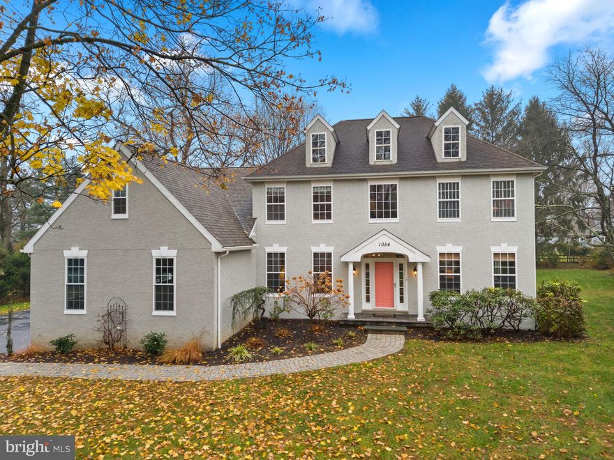 Welcome to 1054 W King Road! This elegant colonial style home is available immediately! Located on a quiet lot at the end of a private drive in award-winning Great Valley School District, this home is waiting for its next adventure! Through the front door, you’re welcomed into the two-story foyer with a lovely turned staircase and warm hardwood floors extending throughout the first floor. On your left is a private home office/study with lighted French doors. On your right, through an arched doorway, is the formal living room leading into the formal dining room. Both rooms have extensive millwork throughout including crown molding and wainscoting. The eat-in kitchen has been tastefully updated with white cabinets, marble countertops, tile backsplash, stainless steel appliance including an upgraded gas cooktop, contrasting color island with seating and glass front display cabinets. From the eating area, you can access the large paver patio and flat backyard via the sliding glass door. The kitchen is also open to the step-down den with a vaulted ceiling, custom gas fireplace and charming window seats. The first floor is completed by the powder room and the mudroom with cubbies, storage bench and utility closet leading to the three-car garage. Upstairs, you’ll find the primary suite with hardwood floors, recessed lighting, convenient laundry room, huge closet/dressing room and a spa-inspired private bathroom.  The bathroom boasts a double vanity, marble tile throughout, soaking tub and an oversized step-in shower with dual showerheads and a bench seat. The rest of the second floor is comprised of three bright, airy bedrooms with plenty of closet space plus a full hall bathroom with a double vanity and tub/shower combination with access to the oversized linen closet on the hall. The finished basement with a powder room offers more living space that’s perfect for a home gym, media room or playroom plus unfinished space for storage. All of this plus easy access to Malvern Borough public transportation, shops and restaurants and West Chester Borough’s vibrant atmosphere! You’re also in close proximity to multiple parks, green spaces and walking trails so you can enjoy the great outdoors whether walking or riding!