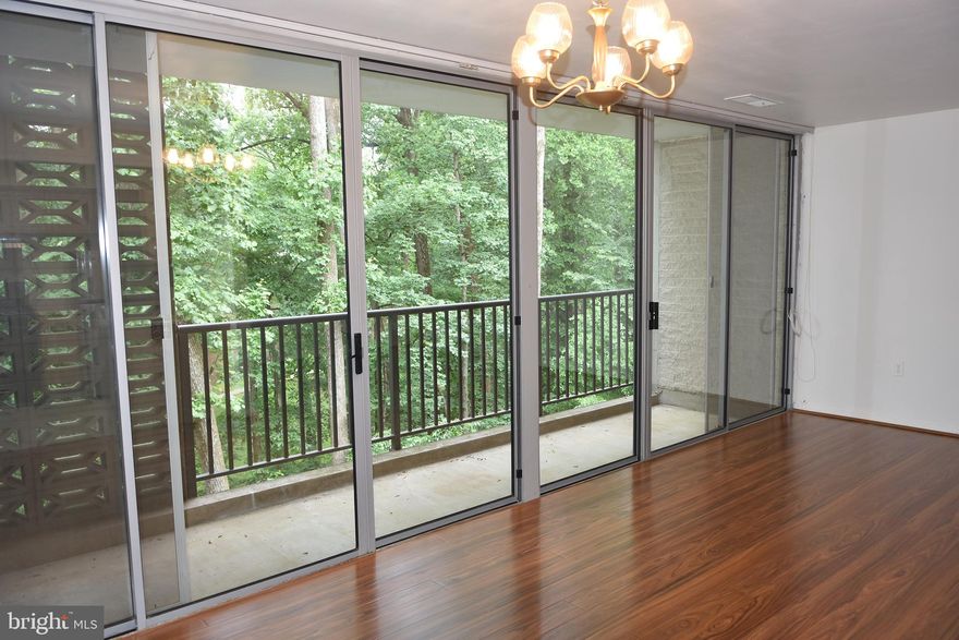 Nice Condo  with 2 bedrooms on second floor.  in great condition ! Open floor plan. Filled with light with wall-to-wall windows. Large living room. Brick wall in dining room. sliding do or to generous size private balcony view of the treed common area. All windows are replaced by condo in 2022. Kitchen updated with new appliances in 2024. Brand new hardwood floor. The building has an elevator and intercom system, Laundry room on each level. Extra storage on the ground floor. condo fees include gas & water. Close to Beltway 495, metro bus stop, shopping center, restaurants. 2 parking permits. Vacant, move-in ready