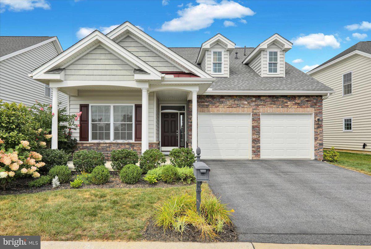 Welcome to 430 Founders Way! This lovely home features a stone veneer upgrade and stately white pillars that define a cozy front porch and beckons you to sit, relax and enjoy the coveted view of open green space that includes a large attractive gazebo. This premium location is just the beginning.
The interior of the home features a convenient den/office located off of the front foyer, pleasing muted color scheme, an open floor plan, and custom upgrades that include a gourmet kitchen with upgraded cabinets, granite countertops, kitchen island, and farm style sink. The Living room boasts of twin custom built-in bookcases that frame the two-sided gas fireplace (living room into primary bedroom) and a vaulted ceiling. The Living Room view flows from the bright sunroom with palladium windows into a screened-in porch and outdoor patio. The generously sized Primary Bedroom features a tray ceiling, walk-in closet, en-suite bathroom with double sink and beautiful tiled shower. There are custom plantation shutters and blinds throughout the first floor. The convenience of a first floor powder room and laundry are a plus. The upper level includes a loft area with dramatic overlook to the Living Room below, 2 large bedrooms (one of which is currently used as a craft room), a Full Bathroom with tub/shower and storage/attic/utility room. Additional mechanical and decorative upgrades can be found in the Documents section. This home is attractively landscaped and centrally located in the community. Schedule your showing today!
Why choose Traditions in Lititz when there are other 55+ communities? Just ask anyone who lives here!
Residents LOVE Traditions of America at Lititz and the high quality of life offered within and surrounding this special community. The amenities are first class and there are a plethora of activities from very enthusiastic Bocce Ball and Pickle Ball groups to Travel, Fine Dining and Life Long Learning clubs.
There are walking paths within and adjacent to the community for nature lovers AND the fact that it is also within walking distance to Lititz, with its friendly sense of community, unique shops, restaurants and an energetic event calendar. It is also close to UPMC Hospital, dentist & doctors, offices for professional services, drugstores, banks, grocery stores, Target, Starbucks, and dining choices.