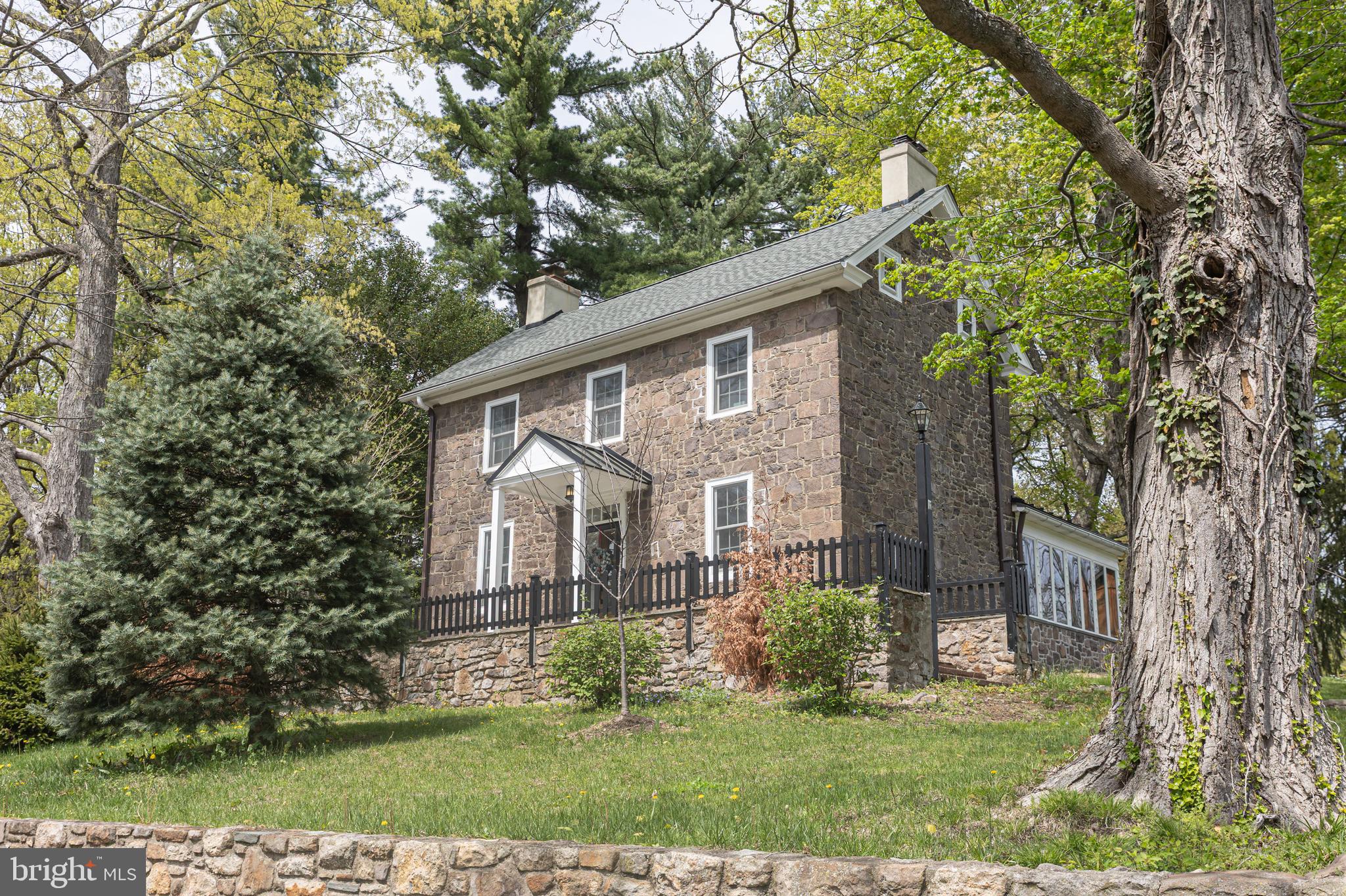 Seize the rare opportunity to own an affordable quintessential stone farmhouse in coveted Doylestown Township, just three minutes from the vibrant heart of Doylestown. Location is everything—and this one is a perfect 10. Nestled on rolling countryside, this remarkable property boasts a stately stone residence, a historic barn brimming with potential, open fields ideal for animal lovers, and a picturesque landscape.
The farmhouse's graceful stone walls and terraces elevate outdoor entertaining, creating an atmosphere of effortless elegance. Adding to the charm of this park-like retreat, Sauerman Park lies just across the road, offering even more breathtaking views of nature. Inside, history and warmth intertwine, with beautiful random-width pine floors, two fireplaces, and a wood-burning stove adding character to every space. Thoughtful updates have transformed it a character "dream home ! In addition, there is a well maintained barn that offers plenty of flexibility for storage, garage space and a 400 s.f. private office space or studio. A joy to show, and an absolute pleasure to represent!