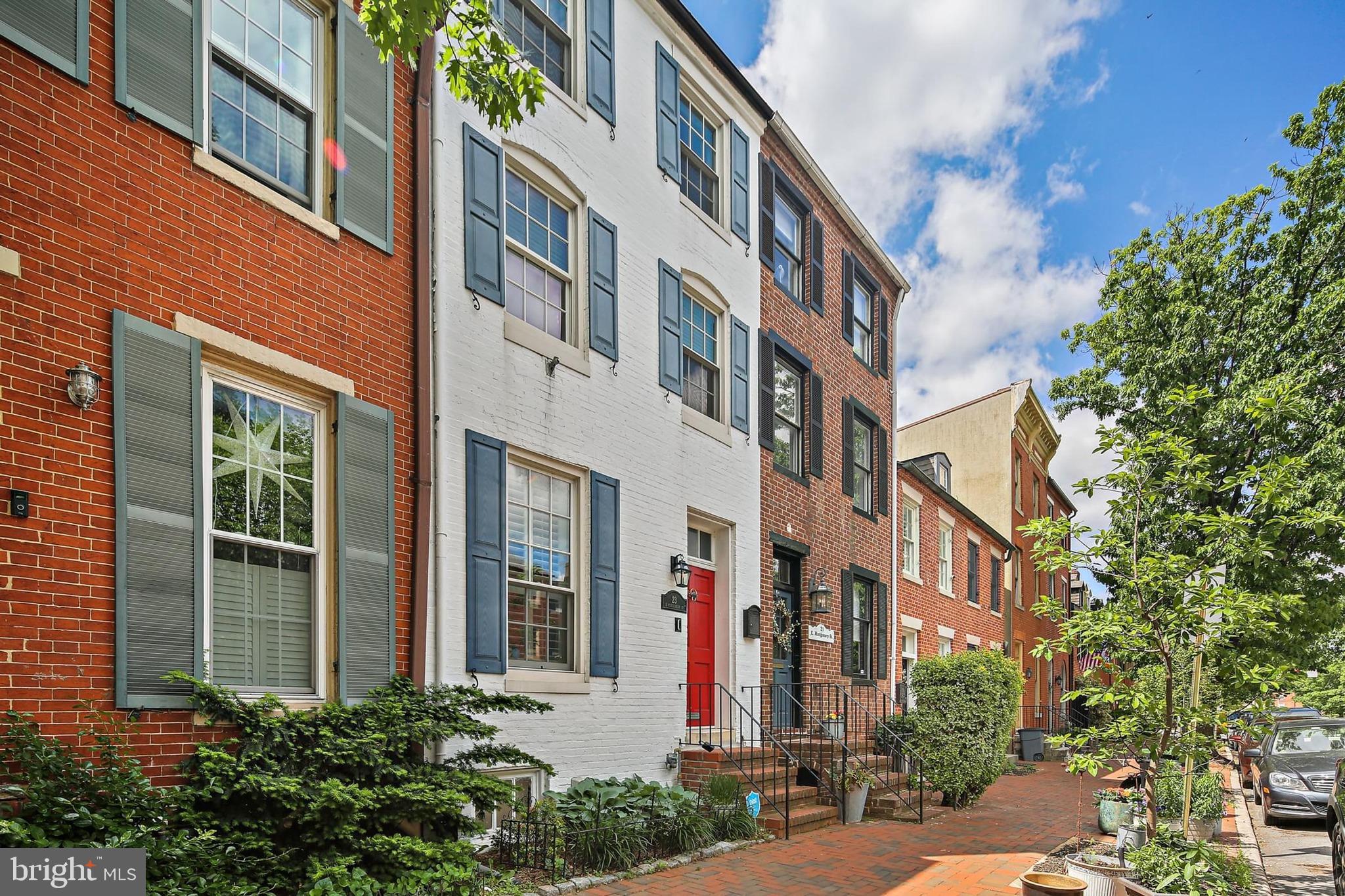 Come check out this well-preserved piece of Baltimore’s history at 23 E. Montgomery Street! Located in the highly sought-after Federal Hill neighborhood, this home is just steps away from restaurants, shops, and everything Fed Hill has to offer.
The main living space on the first floor is sun-filled, with beautiful hardwood floors and a gas fireplace. Next, you’ll enter the round dining room, which has access to a main-level powder room for guests. The dining room flows into an amazing kitchen featuring modern cabinetry, quartz countertops, and stainless steel appliances.
Step outside and enjoy the privacy of your own outdoor space—ideal for summer barbecues or morning coffee. Upstairs, you’ll find two floors with four generously sized bedrooms, all with wood flooring, and two full bathrooms. Both bathrooms have been nicely updated with modern features, including tile-surround showers, updated vanities, and contemporary finishes.
The full basement includes laundry and a large area for storage—or even an exercise room. The rooftop deck is a must-have for Baltimore City living, offering 360-degree views of the city from Federal Hill. A gazebo provides shade and a relaxing spot for warm summer evenings.
This is an exceptional opportunity to own a unique piece of Federal Hill history—don’t miss your chance to call this beautiful home your own. Just steps from the harbor, Federal Hill Park, and the lively bars, restaurants, and shops of Federal Hill.