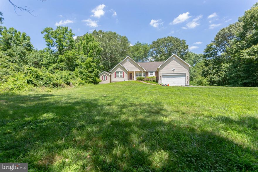 Welcome Home!  No HOA!  Located on a 1.24 acre lot, this 3 bedroom/3 full bath home features an open floor plan, cathedral ceilings, bonus sunroom, finished basement and so much more!  The floor plan features all bedrooms and laundry room on the main level!  The basement boasts a large rec or family room, full bathroom and lots of storage!   With a front yard and backyard that backs to trees, you will enjoy your privacy!  Conveniently located close to Route 1, marina, VRE!