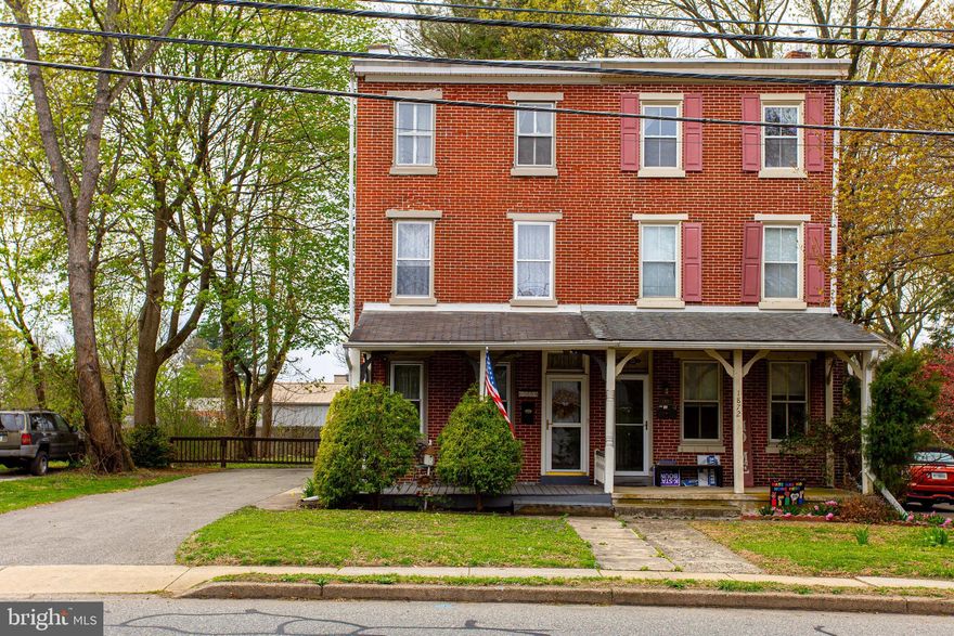 Welcome to 1870 W Marshall Street, a 4-bedroom, 1-bath twin home located in the Jeffersonville community of Eagleville. As you approach the home, a welcoming front porch leads to the entry. Inside, the living room features hardwood floors, crown molding, a ceiling fan with light, and a gas fireplace, creating a comfortable and inviting space. The dining room continues the hardwood flooring and includes crown molding, wainscoting with chair rail, a ceiling fan with light, and wall sconces—perfect for everyday meals or entertaining. The kitchen offers luxury vinyl plank flooring, a ceiling fan with light, and a double sink, providing a functional layout for daily use. Upstairs on the second level, the primary bedroom features hardwood floors and crown molding. The full bathroom includes tile flooring, crown molding, wainscoting, and a tub/shower combination. A second bedroom on this level offers carpet flooring with hardwood floors underneath, along with crown molding and a ceiling fan with light. The third level includes two additional bedrooms, both with hardwood floors, offering flexible space for children, guests, or a home office. Out back, a rear porch provides a great spot for morning coffee or relaxing evenings and access to a spacious yard. Conveniently located near local shopping, grocery stores, multiple golf clubs, and more, this home also offers easy access to major roadways for commuting. Don’t miss the opportunity to make 1870 W Marshall Street your new home.