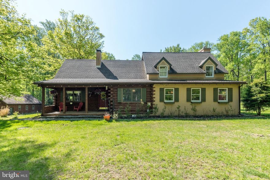 Set on 12 private acres in desirable Bucks County, this stunning log cabin home offers the perfect blend of rustic charm and modern comfort. From the moment you step inside, you’ll be captivated by the warm wood finishes, soaring ceilings with beams, and inviting living spaces. The main level features a spacious living room with a dramatic stone fireplace, wood-burning stove, and rich wood floors and ceilings. A private office with exposed beams provides the perfect work-from-home space, while the expansive family room complete with built-ins, a propane fireplace, and access to a enclosed porch create an ideal setting for relaxing or entertaining. The kitchen offers a dining area, tile backsplash, and counter seating, complemented by a large separate dining room. Upstairs, a versatile loft with cabinetry and potential laundry space overlooks the home’s interior. The primary bedroom features crown molding and a double-door entry, while two additional bedrooms offer generous space and character and great closet space. A full bath with radiant heated floors and a jetted tub adds a touch of luxury. The finished lower level serves perfectly as an in-law suite or private retreat and has been completely updated! It features a full kitchen with granite countertops and upgraded cabinets. A large living area, spacious 4th bedroom, and full bath complete this level.  The utilities are on this level with a laundry area and access to the new well pump with UV filtration system. Outdoor living is just as impressive, with a three-season room and expansive acreage offering privacy and endless possibilities.  Completing the property is a fully upgraded 30x40 detached garage with heating, cooling, and spray foam insulation ideal for hobbyists, car enthusiasts, or additional storage. This one-of-a-kind property combines peaceful country living with thoughtful upgrades throughout and is an exceptional opportunity in Bucks County.  Don’t miss this one!