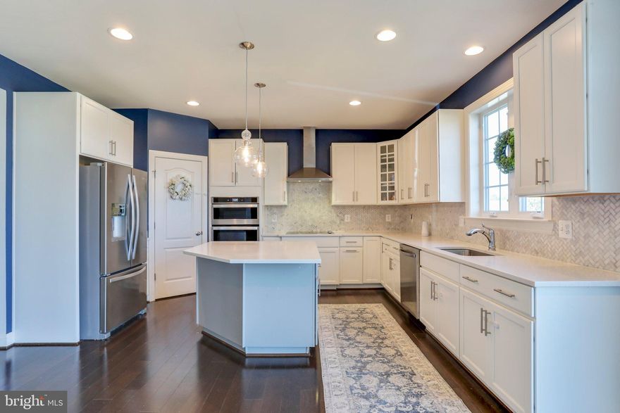 Spacious and well-designed home with a deck and fully-fenced yard. The combination of over 4,000 square feet, a 2-car garage, and a corner lot adds to the overall appeal.

The inclusion of four bedrooms and 3.5 bathrooms provides ample space for comfortable living. The gourmet kitchen with high-end features such as white quartz countertops, wall ovens, electric cooktop, vented hood, and stainless steel appliances adds a touch of luxury. The flooring choices, with Mocha 5" engineered hardwoods on the main level and 12mm luxury laminate throughout the upper and lower levels, contribute to both style and practicality.

The family room, wired for surround sound, and featuring a wood-burning fireplace with a blower, creates a cozy and entertainment-friendly atmosphere. The lower level, with its open layout, full bathroom, wet bar, wine fridge, and unfinished storage room, adds versatility to the living space.

It's a well-equipped and thoughtfully designed home. Low HOA fees. 

Interest rates have dropped, but you may qualify for the  WVDHF HOMEOWNERSHIP PROGRAM with a 30 YEAR INTEREST RATE OF 5.640%. NO POINTS. ONLY NEED 5% DOWN.