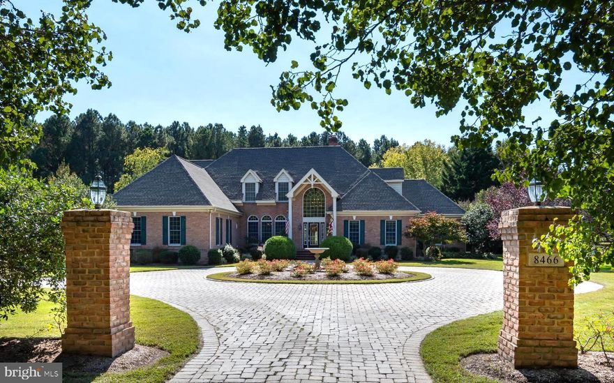 This private retreat, ideally positioned between historic Easton and St. Michaels, offers the rare combination of privacy, acreage, and refined living that buyers seek on Maryland’s Eastern Shore. Set on more than six beautifully landscaped acres, the property includes a striking 4,800‑square‑foot all‑brick Colonial residence, an expansive concrete pool with a screened entertainment pavilion, a versatile 60' x 30' Morton building, and frontage on a freshwater pond with peaceful views extending toward the Miles River.  The residence was just connected to our county sewer system which provides ultimate flexibility for future expansion of the home if desired.   *  The home’s exterior is designed for low‑maintenance living with full brick construction, a new roof, a paved drive and circular turnaround, generous parking, brick walkways, and a concrete pool surround. Inside, the first floor features oak hardwood floors, high ceilings, and impressive room sizes. The living room with fireplace, formal dining room, and private office or den with powder room create an elegant and functional layout. The renovated gourmet kitchen includes granite countertops, a tile backsplash, stainless appliances, and opens to a breakfast room and a spacious family room with a vaulted ceiling and cozy fireplace. The first‑floor primary suite serves as a true retreat with a vaulted ceiling, fireplace, oversized walk‑in closet, luxurious bath, and an adjoining flex room ideal for a gym, office, studio, or hobby space. A well‑designed mudroom, laundry with cabinetry and sink, and an additional powder room connect conveniently to the oversized two‑car garage.  *  The second floor offers a private guest suite with its own bath, two additional bedrooms, a hall bath, and a large bonus or game room. Dual staircases — a formal front staircase and a back staircase leading to the kitchen and family room — enhance both convenience and privacy.  *  Outdoor living is a highlight of this property. The large concrete pool and screened pavillion create an inviting setting for warm‑weather enjoyment. Mature, thoughtful landscaping surrounds the home, while the Morton building with four overhead doors provides exceptional flexibility for boats, RVs, car storage, or workshop needs. The freshwater pond at the edge of the property adds a serene natural element, with pondside views stretching toward the Miles River.  *   The home has been meticulously maintained and significantly improved. Recent upgrades include a renovated kitchen and dining area with new fixtures, backsplash, wallpaper, and stainless appliances; a 5‑ton Carrier high‑efficiency heat pump  for 1st floor installed in 2011; Bryant 2.5‑ton upstairs AC unit installed in 2018; 2023 electric hot water heater; fresh exterior painting of the house, cabana, and barn trim in 2016; and a new GAF Weather Stopper 50‑year roof with transferable warranty added in 2018. The Morton building received a new steel roof in 2019. An 18.6 kW grid‑tied solar array was installed on the barn roof, covering approximately 90 percent of the home’s annual electric use. Atlantic Broadband service was extended to the property for reliable internet access. Additional enhancements include custom mosquito curtains for the cabana, a new pantry under the stairs, a fully remodeled downstairs bath, and an upgraded primary bath with new double vanity, granite, fixtures, and mirrors. Extensive landscaping improvements include new trees, raised garden beds with irrigation, refreshed poolside plantings, a new picket fence with hydrangeas and iris, and upgraded perennial gardens featuring a wide variety of seasonal blooms.  Quarterly public sewer fee $231.25.