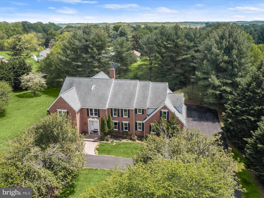 Magnificent Estate in the Coveted Glenelg Estates. Welcome to this stunning home that exudes timeless elegance and exceptional functionality. Nestled in the sought-after Glenelg Estates, this remarkable property boasts a unique indoor basketball court, perfect for avid entertainers or those with an active lifestyle. With generous space for multi-generational living or the potential to serve as a charming bed and breakfast, this estate offers endless possibilities. Step through the grand two-story foyer, where sophistication meets comfort. The formal living and dining rooms, adorned with crown molding, chair rail accents, and expansive sunlit windows, create a warm and inviting ambiance. The family room, the heart of the home, features a soaring ceiling, gleaming hardwood floors, and a dramatic double-sided wood-burning brick fireplace. The lovely kitchen is equipped with an oversized center island, sleek countertops, a stylish tile backsplash, stainless steel appliances, recessed lighting, and a convenient pantry. A casual dining area complements the space, while direct access to the indoor basketball court makes this home a true entertainer’s dream. Unwind in the sunroom, enhanced by a vaulted ceiling and skylights, offering a serene retreat after a long day. The main level also includes a bedroom suite with an adjoining full bath, a convenient laundry room, and additional storage space. Ascend one of two staircases to discover the opulent primary suite, featuring a private sitting room, dual walk-in closets, and a dressing area. The spa-like bath includes dual vanities, a luxurious jetted soaking tub, an oversized shower, and a private water closet. Three additional generously sized bedrooms, one with hardwood flooring and a dual-entry bath, provide ample comfort for family and guests. The finished fourth-level loft offers flexibility as an additional bedroom, home office, playroom, or creative space. The fully finished basement is designed for maximum enjoyment and versatility. It includes a spacious recreation area, exercise space, game room, and a full bath. Four additional finished rooms provide endless opportunities to use them as optional bedrooms, a hobby room, media center, second office, or a meditation space. The rear deck is perfect for summer barbecues, overlooking a picturesque, tree-lined view that offers peace and privacy. With unparalleled space, thoughtful design, and a host of premium features, including the rare indoor basketball court, this estate is truly one of a kind. Don’t miss this incredible opportunity to own a home that seamlessly blends luxury, location, comfort, and versatility.