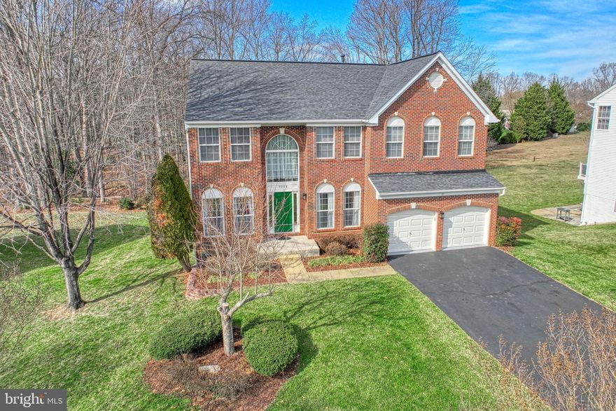 If you are looking for a beautiful home on a large lot in a quiet cul-de-sac backing to the trees in a safe family friendly community, then your search is over! This is a gorgeous brick front colonial style one owner meticulously maintained hypoallergenic single-family home with an attached two car garage in the sought-after Blooms Crossing Subdivision of Manassas Park. This home has 9 feet ceilings and hardwood floors on the main level with five bedrooms on the second floor, four total bathrooms and a finished basement with walk-out door. It has been freshly painted, with new carpets on the upper floor, LED lights and fixtures, water saving elongated toilets and is move-in ready.

The inviting front entrance leads into a two-story foyer flanked by a bright living room and formal dining room that leads into the family room, study and kitchen. The warm family room with floor to ceiling stone gas fireplace has generous space for entertainment and family gatherings. The spacious open kitchen consists of an island, eat-in breakfast area and a walkout sliding door to the newly painted deck. The kitchen has 42” tall cabinets, granite countertops, glass tiled back splash, stainless-steel appliances (5-burner gas cooking range, double oven, dishwasher, double-door fridge) and a walk-in pantry.

The second-floor extra-large master suite has vaulted ceilings, ceiling fan, walk-in closets with his and hers sections. The attached master bath has a double sink vanity, glass walk-in shower and large soaking tub. There are four additional spacious bedrooms with walk-in closets that share a full bath with double sink vanity and tub with shower, and the hallway has a separate linen closet. The outdoor deck has stairs to a large paved patio and a gently sloping backyard surrounded by tall trees is perfect for cookouts. The finished basement with a full bathroom, two additional rooms that can be used as den or home office or guest bedrooms and a home theatre/gaming room with a wet bar with two full size windows and a walkout door to patio completes the entire package.

This friendly neighborhood is within a short walk to two public elementary schools and private school, Blooms Park hiking trails, and the popular Signal Hill Water Park. Centrally located within minutes to shopping & popular restaurants on Liberia Avenue, route 28 and the nearby VRE train station that connects to DC.

Selected recent upgrades & improvements – (all dates are approximate to the best of owners’ recollection)
2023 – Fresh paint, new carpets in the bedrooms, hallway and stairs, new light fixtures with LED lights, new water saving toilets, garage door opener
2021 – New counter depth side-by-side refrigerator
2019 – New Carrier air-conditioning, furnace and AprilAire filter; Rheem Gas water-heater
2018 – New Kitchenaid stainless-steel appliances (5-burner gas cooking range, range hood, double oven, dishwasher)
2017 – Bathroom remodel with porcelain tiles, glass showers
2016 – Roof replacement
2014 – Kitchen remodel, granite countertop and installed hardwood floor on main level