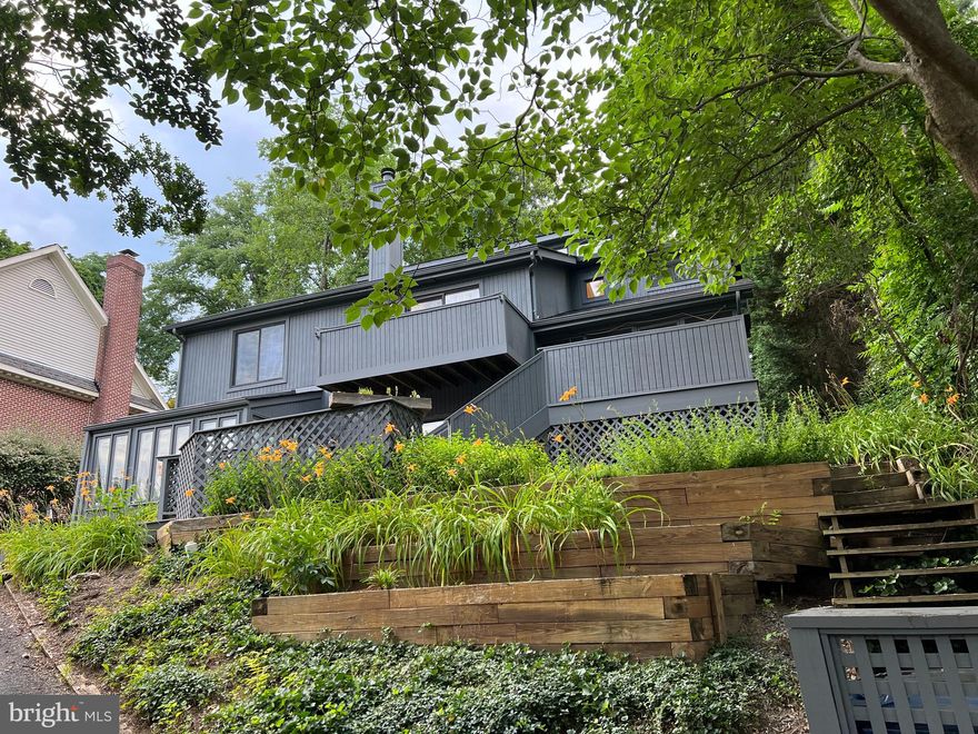 Amazing four-floor five-bedroom split-level contemporary available in Rosemont. Fresh paint, polished floors and ample outdoor space with three tiered terraces for morning coffee or friendly BBQs. A separate entry is followed by an open floor plan living with fireplace and french doors to the first terrace. The dining room is perfect for family meals, with sliding glass doors to the rear stone patio. The open kitchen has a separate breakfast room that leads to a screened-in porch and a tiered wood deck. The upper two levels include an open office/den, four sizable bedrooms, two full baths and a laundry room. The lower level is complete with a family room, glass solarium and fifth bedroom that graciously welcomes out-of-town guests, an au-pair or family members for an extended visit. Plenty of interior options for unique living situations or working from home. Off-street parking for several cars. Easy access to two Metros, Delray and Old Town.