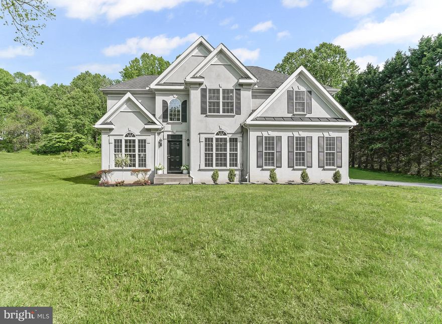 This custom built executive home is located on a gorgeous 1.1 acre lot within WALKING DISTANCE to WHITE CLAY CREEK PRESERVE (miles of hiking & mountain biking trails), 10 min. to the University of Delaware, and within the award winning Avon Grove School District. The home features cherry wood flooring in the foyer, fresh new carpet throughout,  and a remodeled eat in kitchen with beautiful, leathered, granite counter tops, new tile floors, a large breakfast area with access to the backyard for easy grilling and entertaining, plus a huge walk in pantry.  The chef's dream kitchen also has a double wall oven and a separate gas cooktop.  The kitchen and family room are OPEN CONCEPT and the entertaining flow from one to the other is what every host dreams of.   The main entry is flanked by the formal dining and living rooms and has a lovely hardwood staircase to the upper levels.  The primary bedroom is generously sized with a large primary bathroom complete with a separate toilet room, custom shower, and large soaking tub.  The master closet is a large walk in space which also conveniently houses the washer and dryer.  There are three additional bedrooms and a second full bathroom on the upper level.   The views from all the bedrooms are amazing with the surrounding woods.  There is a babbling stream that runs along the property line.  This home is a nature lovers' hideaway, in move in ready condition with nothing to do but bring your walking/hiking stick or mountain bikes and move right in. Don't miss this well maintained gem!  One you see it you will surely want to call it home.
