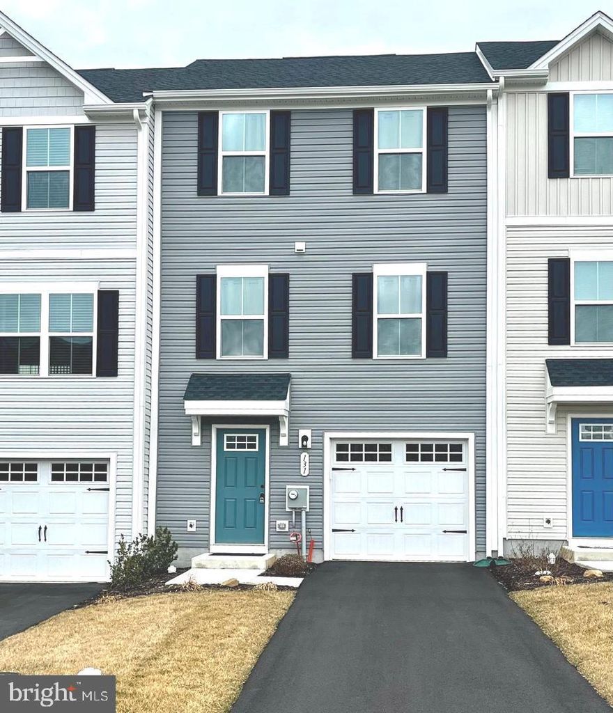 Welcome to this new  Valley Square Towns community and 1 year old townhouse Ready to Rent. You enter this 3 story home from the lower level into a foyer and access to the 1 car attached garage. This level also offers a versatile flex space, perfect for an office, den, home gym, or playroom. On the main level, the open concept floor plan includes  kitchen , dining area and large living room, perfect for relaxing or entertaining. A convenient half bath is also located on this level. The upper level features three bedrooms and two full bathrooms, including a the primary suite with its own en-suite bath and walk-in closet. For added convenience, the washer and dryer are located on this level. Situated on a premium lot that backs up to school-owned land, this home offers both privacy and peaceful views. Included in the rent is lawncare and trash removal.