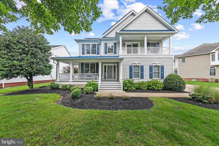 Simply stunning pond-front home in the desirable gated community of Bethany Lakes, just minutes from Bethany Beach. This spacious residence was thoughtfully designed to offer plenty of room for everyone to gather, while also providing private retreats to spread out and relax. At the heart of the home is a soaring two-story family room, fully open to a beautifully remodeled gourmet kitchen. The kitchen showcases new quartz countertops, a tiled backsplash, a center work-station island plus a larger breakfast bar island with generous seating, a walk-in pantry, and stainless steel appliances—including a beverage fridge. A dining area flows seamlessly into a bright sunroom, while the opposite side of the kitchen opens to additional living space off the foyer. The main-level primary suite has been recently renovated with a spa-inspired bathroom featuring a glass-enclosed shower, dual sinks, and elegant tile finishes. Upstairs, a spacious loft offers the ideal spot for a second family room, along with four generously sized bedrooms and two full bathrooms. Step outside to the waterfront deck and take in peaceful pond views, with ample space to add a pool or design your dream outdoor living area. Additional features include an encapsulated crawlspace for peace of mind, a two-car garage for beach gear, an outdoor shower, and owned solar panels generating $1,800–$2,000 in annual credits. Offered fully furnished, this home is ready to be enjoyed. Bethany Lakes offers resort-style amenities including a swimming pool, tennis and pickleball courts, a community center with fitness facility, and weekly lawn maintenance—all within a beautifully maintained gated neighborhood.