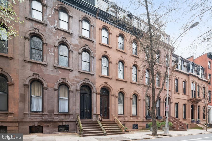 Unbelievable opportunity to enjoy over 2400 square feet of graciously renovated living space with ONE CAR PARKING  in the heart of Rittenhouse Square! Perfectly situated on your favorite block just steps from the square, this stunning bi-level space is the top two floors of a historic 1870's brownstone mansion. It seamlessly blends the grandeur of the past with today's comforts and conveniences. The light filled living room of this special property spans an incredible 27 feet overlooking the treetops of Spruce St from the stately windows. The eat-in  kitchen beautifully melds old and new with plaster moldings and a beautiful fireplace with modern touches like Jenn Air appliances, breakfast bar, great cabinet space, and granite counters. The south facing primary suite features a large marble bathroom with radiant floors and plentiful closet space. Convenient laundry room on this level. 
Upstairs are two spacious bedrooms, a beautiful bathroom, and a bonus space perfect for watching TV, working or studying from home. 
If you desire more private outdoor space beyond the park, there is an opportunity to create a roof deck off of this floor. Pet friendly building with low condo fees.
Don't miss your chance to live in the heart of it all in timeless elegance!