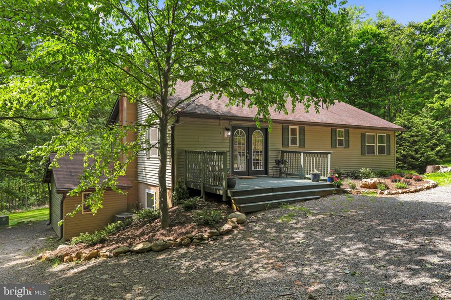 Great Investment Property and Home: 4 BR/3 Bath Newly Renovated Very Private Gorgeous Home on 20 ac. Near Coolfont Resort and just 3 miles from Berkley Springs, this home sits on 5 stunning Recorded Lots, all sold together, for a total of over 20 acres. All for $450k! 
The Home: Beautiful and Thoughtfully Renovated! This Very Private 2576 Sq.Ft Rancher has been remarkably renovated. The home's freshly painted interior shows off all new Stainless Steel Appliances including a large Kitchen Sink w/ spray handle, Stove, Micro wave, Dishwasher, and Refrigerator. The addition of a NEW maple butcher block counter top and a NEW kitchen island highlights a chef’s kitchen that feels contemporary and compliments functionality. The Master Bedroom suite with a spacious walk in closet, double person soaking tub, and bath with 2nd bedroom with 2nd bath all on main level have each been meticulously updated and provide for a modern experience while still maintaining the charm of the home. 
The downstairs houses a separate laundry room, separate kitchen, stove, refrigerator and lots of cabinets and additional storage making an ideal mother-in-law suite, or a place for teens to get away. New engineered flooring in the two bedrooms. New hot water heater and heat pump installed in last 3 years and a new  large septic field all make certain that the home is move-in ready. 
Not to be outdone, the exterior has been updated as well. Newly painted deck boards, front and back, along with a roof in excellent condition (2014), new gutters, down spouts and gutter guards, and professional landscaping, ensure overall appeal upon arrival. 
Property backs up to Warm Springs Ridge keeping it private and quiet from Rt.522 noise. As the video tour shows, the mature trees provide both a beautiful lush green setting as well as an intimate oasis away from urban distractions. While the foliage provides cover from even your closest neighbor, you will delight in home’s proximity to the many activities and pursuits the region has to offer. Close to Coolfont (5 minutes), Berkeley Springs (8 minutes), Winchester Va (30 minutes) and I-70 (20 minutes). 
Attached in the DOCUMENTS section you will find a detailed plat of the 5 lots (each between 3-5 acres), individual lot sale projections, and current market Financial Comps. The value of this GEM of a property is unmatched.