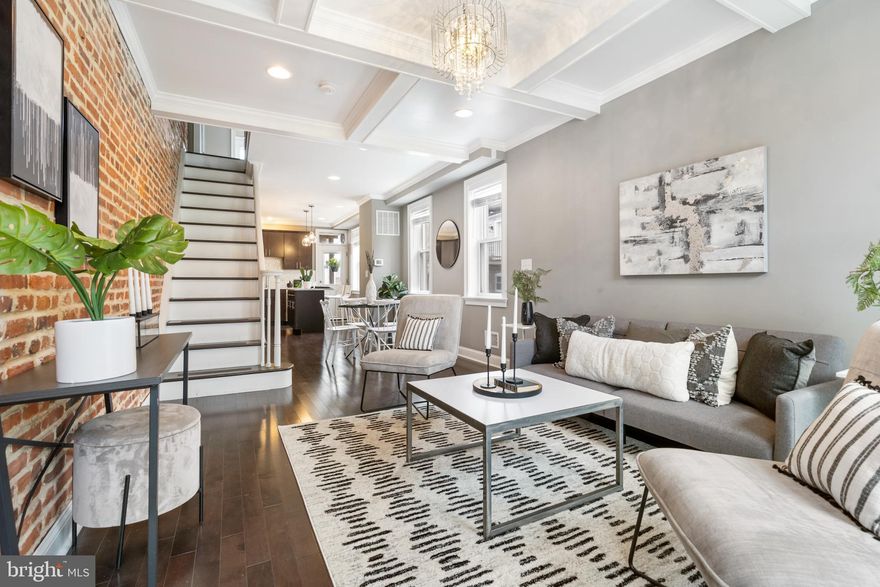 3 years left of CHAP, $4300 per year in tax savings!! 
In the sought after Canton area, enjoy the benefits of the city lifestyle.  One great benefit of being here, you are close enough to walk down and enjoy the dinner on the water, grab a drink at one of the many local watering holes. Come home and enjoy many upgrades, modern amenities & exceptional classic design in this beautifully renovated home!  You are welcomed by gleaming hardwood floors throughout this open concept home. Notice the impeccable finishes like the coffered and tray ceilings, recessed lighting & crown molding. Quartz countertops, tile backsplash, tons of cabinets and counter space, kitchen island, and stainless steel appliances make this the kitchen of your dreams. Follow the classic brick wall upstairs to your bright and airy primary bedroom with tray ceilings and hardwood floors. Two closets in this room allows you to never worry about where to put your clothes! You will find your second bedroom right across the hall. Turn this room into a guest room or an office. Either way, you get to utilize the second story deck right off this room. Waking up and walking outside to get a breath of fresh air, nothing is better! The top level is rounded out with a spacious custom bath. Nothing better than standing under the waterfall shower after a long work day. Have you always wanted your own movie room? Look no further!!! Your finished basement has the PERFECT room for this. With a built-in shelf perfect for your projector or TV, you couldn't ask for better. Not a huge movie fan? No worries, this space can be whatever your heart desires. Third bedroom, Yoga room, at-home gym, or game room; the options are endless. You will find your second full bath and laundry for easy access down here as well as extra storage and access to the patio. Thank goodness it's summer!! Your spacious backyard is ready to host all the BBQs and gatherings you can handle or use as a parking pad. Close to Canton Square and Canton Crossing, Greektown, Inner Harbor, tons of restaurants and shopping, Johns Hopkins Hospital as well as RT-40, I-95, and much, much more. Do NOT miss your chance to own this gorgeous Charm City gem!