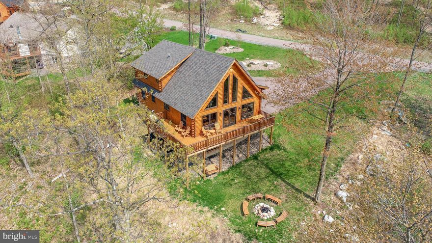 Escape to the pinnacle of mountaintop living at Moonlight Ridge, an idyllic retreat located within the exclusive North Camp Community. This stunning, quality cedar log home offers a perfect blend of rustic charm and modern convenience. Boasting 5 bedrooms and 3 baths, this property is a true gem. When you first step onto the spacious front porch with its dramatic peeled log posts and rafters, you’ll feel like you’ve arrived at a lodge. Inside, you'll be greeted by the warm and inviting open floor plan, highlighted by a cozy stone fireplace in the living room. The large, cathedral-like windows throughout not only fill the space with natural light but also provide captivating views of the majestic mountains and stunning sunsets. The main level of the home features two bedrooms, a full bath, and convenient laundry facility, ensuring comfort and ease of living. The fully finished basement is an entertainer's delight, with a spacious game room and two additional bedrooms, along with another full bath. The upper level offers a large and versatile loft area, perfect for use as a workspace or additional living space. The primary bedroom awaits, complete with its own private bathroom and a generous walk-in closet and storage area. Outside, the property is adorned with beautiful landscaping. The side and back decks, along with the front porch, provide the ideal spaces for relaxation and outdoor enjoyment. For added privacy and relaxation, a hot tub is tucked away below the deck. And for those tranquil moments, a porch swing is thoughtfully placed under the deck along with a fire pit just steps away, allowing you to fully immerse yourself in the breathtaking surroundings. Located only minutes from the plethora of activities that have made Deep Creek Lake a beloved destination! Incredible rental history. Call today!