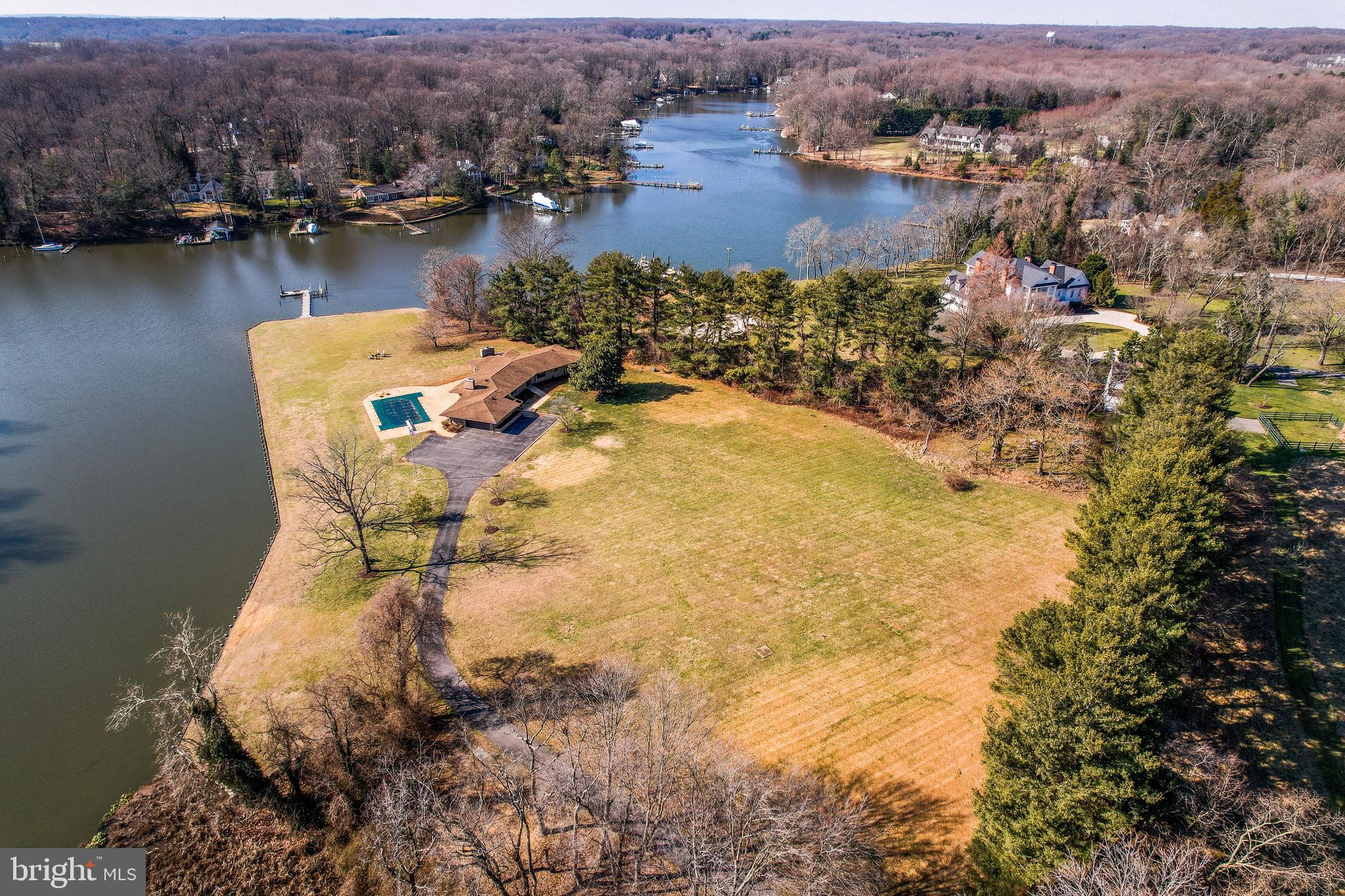 Jenkins Lane is an extraordinary private estate on deep water, nestled along Whitehall Creek with direct access to the Chesapeake Bay. This exquisite property spans over 5 acres, featuring a tree-lined driveway that leads to the electronic gated entrance. Upon arrival, you'll find a side-entry, oversized two-car garage, offering plenty of additional parking space for guests.
With over 700 feet of bulkheaded waterfront, the property offers a private pier complete with a 10,000-pound boat lift, three slips, water, electric, and 6+ feet of Mean Low Water (MLW) — perfect for boating enthusiasts and waterfront living. The expansive grounds are thoughtfully designed, showcasing a large patio and a waterside saltwater pool, where you can relax while enjoying breathtaking, unobstructed views of the creek, complete with picturesque sunsets that are truly one of a kind.
The recently renovated home embraces an open floor plan, ideal for both casual living and entertaining. The chef’s kitchen is equipped with premium stainless steel appliances, a large island, and plenty of prep space. Just outside, a screened porch offers a serene spot to unwind.
The lower level is perfect for entertaining, featuring a spacious entertainment area, a full wet bar, a wine closet, and a newly updated full bath. Ample storage space ensures that all your belongings have a place.
As an added bonus, this property includes an additional .66-acre potentially buildable lot, further enhancing its value and potential.
This is a rare and special opportunity to own a premier waterfront estate that combines luxury living, extensive outdoor amenities, and endless possibilities.
Motivated seller. Seller will consider and entertain all reasonable offers. This beautiful property is priced well below the appraised value.