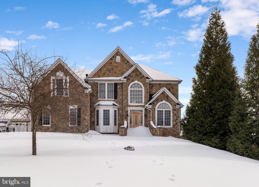 Stunning stone-front Colonial offering over 6,000 square feet of beautifully finished living space, set on a private lot exceeding one acre. Designed for both everyday comfort and entertaining, this home features an open-concept layout with soaring cathedral ceilings that flood the interior with natural light and create an impressive sense of scale. The fully finished basement expands the living space even further and includes a dedicated theatre room—perfect for movie nights, sports, or entertaining guests. Outdoors, enjoy the Trex deck overlooking the spacious yard, ideal for relaxing or hosting gatherings. With timeless curb appeal, generous proportions, and a rare combination of space and setting, this property offers exceptional versatility both inside and out.
