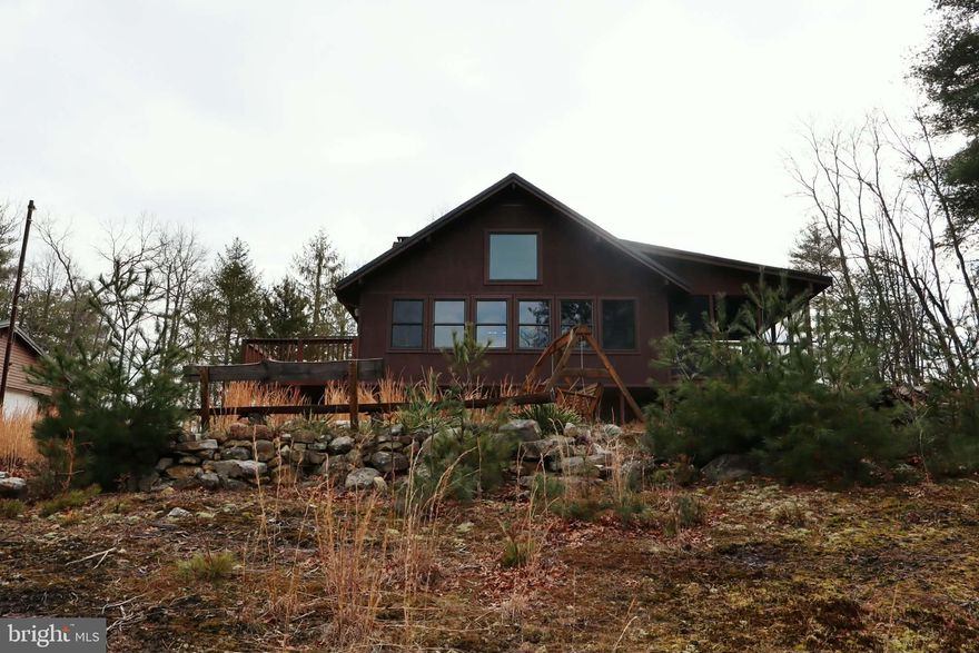 Escape to the ridge and experience true mountain living in beautiful Pendleton County. Nestled on nearly 16 acres atop Sandy Ridge, this rustic cabin offers the perfect blend of privacy, comfort, and breathtaking views.
Inside, you’ll be welcomed by a stunning stone fireplace that anchors the main living space with warmth and character. The home features 2 bedrooms and 3 full bathrooms on the main level, including a spacious primary suite with a recently added private bath — creating a true en suite retreat. A charming loft serves as the third bedroom, overlooking the living area below and capturing the beauty and openness of the home.
Because this cabin sits along the ridge of Sandy Ridge Mountain, you’ll enjoy both sunrises and sunsets — a rare and remarkable feature. The backyard firepit area, complete with seating, overlooks rolling mountain views with a peek-a-boo opening through the trees that frames those unforgettable sunset skies.
Additional highlights include a deck, screened-in porch for peaceful evenings, detached garage, and a garden area ready for your homesteading dreams.
Privacy. Views. Rustic charm. Nearly 16 acres on the ridge.
Don’t wait too long — or this property will be GONE.