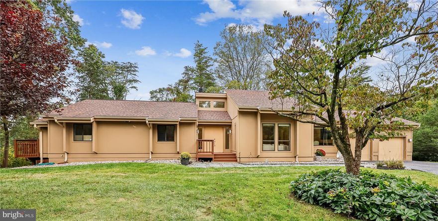 Don't miss this architecturally designed, custom-built ranch , crafted with the art enthusiast in mind. This remarkable home showcases soaring ceilings, a loft  overlooking the living, dining and family rooms (ideal for displaying pottery or statuary etc.), and expansive walls of windows in the breakfast area, family room and primary suite. Thoughtful niches throughout provide space for glassware and decor.
Step outside to a spacious deck that runs the length of the home and offers lovely views of the private 1.17 acre lot. With approximately 4,740 sq. ft. of living space, the unique home includes 4 bedrooms, (including a spacious primary ensuite having 3 closets, one, a walk in),  3 1/2 beautifully renovated baths, and a finished walk-out lower level, complete with bedroom, full bath, office, sauna and plenty of room for a game area or man cave. Conveniently location near Shady Grove's educational and medical centers. and shopping.