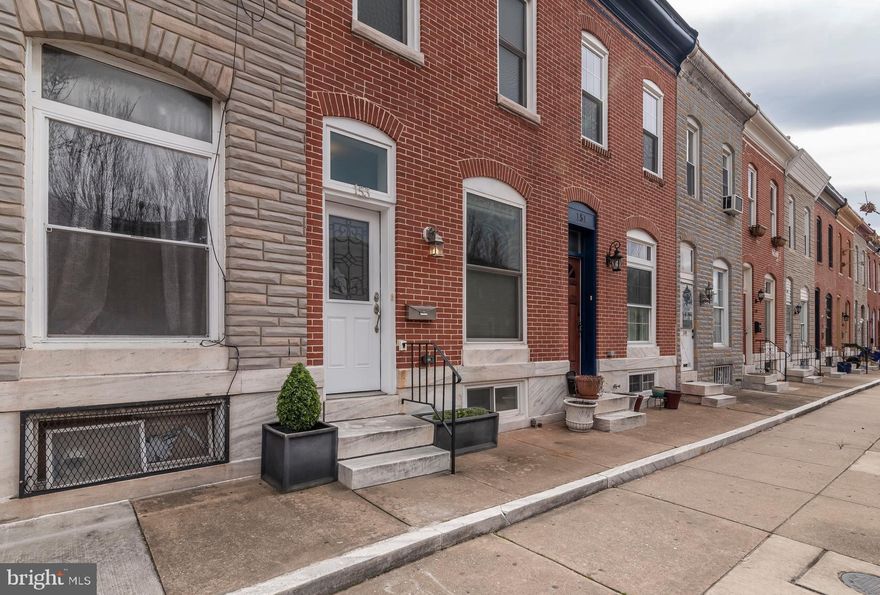 Located steps from Patterson Park, this recently renovated rowhome features an open floor plan with tall ceilings, exposed brick, original hardwood floors, and built-in book cases. The main level includes a large living room, dining room and a chef's kitchen with a wine fridge in the bar area. The bedroom level offers 2 spacious bedrooms with lots of closet space and 2 full bathrooms. The finished lower level is great for a tv room, office or guest space. The back half of the lower level provides plenty of storage and the laundry area. Step out back and envision the cookouts, container gardens and fire pit you can have on the bluestone patio. Don't miss out on this one!