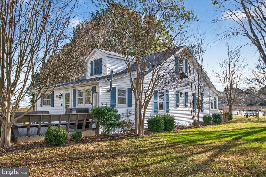 THE BEST EASTERN SHORE WATERFRONT VALUE
Where mornings begin by the water and plans tend to follow the tide, this Eastern Shore retreat blends relaxed waterfront living with thoughtful design by respected local architect Pam Gardener. Warm woods and a naturally flowing layout create easy and inviting view-filled spaces where you’ll prep picnics and gather for afternoons in. Comfortable for both small gatherings and full summer house occasions, you’ll savor rainy-day reads in the home’s tranquil waterside sunroom, while rip-rapped shoreline and decking set the stage for crab feasts, firefly-lit dinners, and afternoons that drift happily off schedule. Your private pier, with floating dock and boat lift, launch adventures, provide a place to spot wildlife, and host impromptu swims. At day’s end, evenings are cozy in four restful bedrooms accommodated by two baths suiting both weekend escapes and longer stays. With generous storage, timeless finishes, and a long list of upgrades, the home feels ready to be enjoyed. While on tour, visit the canoe rack, storage shed, two car garage with EV charger, and stroll the gently sloping lawn leading to the water’s edge. Just minutes from St. Michaels’ antique shops, marinas, and winding back roads, this is Eastern Shore living at its best.


2026 is the planned year for the public  sewer hook up which will enable the new owner to build a pool and expand adding more property value.
Significant renovations and an addition were completed in 2001, including a new septic system. Recent upgrades feature an encapsulated crawlspace,  kitchen countertops (2020),  Bailey dock with oversized floating dock and sundeck (2013), added power boat lift (2023).
Modern conveniences include new washer and dryer (2024), dishwasher (2022), new refrigerator (2024), leaf filter system on house and garage (2022), updated 2nd floor bathroom (2024), new well pump and bladder tank (2022), replaced waterfront portion of roof (2002) the front portion (2019), upgraded electrical service to garage and sheds, including electric vehicle charger (2024), replaced pump to house heater (2024), freshly paved asphalt driveway, new garage doors (2023).