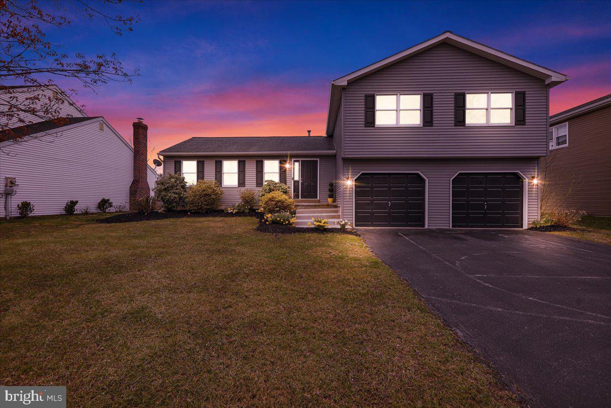 Discover this charming residence, thoughtfully designed to offer both elegance and comfort. Nestled within a picturesque setting, this home boasts a scenic vista, and large backyard that provides a serene backdrop for everyday living. Step inside and be greeted by a living room and formal dining area adjacent to the kitchen for entertaining guests or enjoying quiet moments with a half bathroom located nearby. The family room, with its inviting ambiance, features a cozy fireplace—ideal for gathering with loved ones, and glass doors accessing the backyard. The finished basement offers another gathering space for play or relaxing with a large storage area and the laundry room close by. The oversized two car garage has easy access to the family room, with ample space for storage. Upstairs has 4 bedrooms and 2 full bathrooms, one located within the primary bedroom which also has a walk-in closet, and beautiful view of the backyard and adjacent scenic valley.