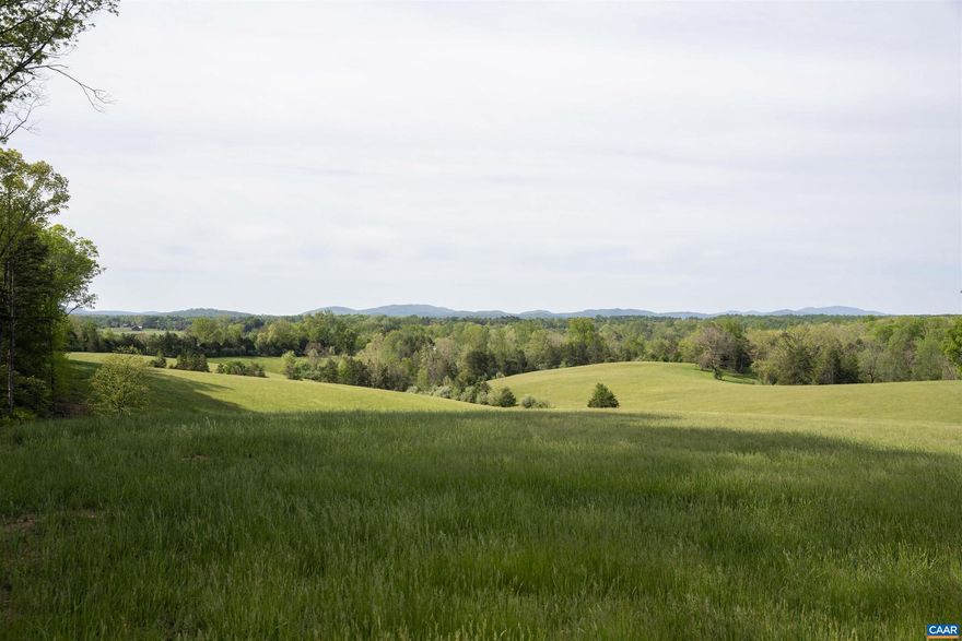 A breathtakingly beautiful 98 acres (2 parcels) with long dramatic views of both the Blue Ridge  and SW Mountains in a rural, protected area, minutes from town. No houses can be seen in the 180 degree main viewshed.  The rolling 92 acre parcel is a good mix of productive pasture and hardwoods with a spring-fed pond.  A thoroughly renovated three bedroom cottage and new, oversized garage are ready for occupancy or build your dream home on a level, elevated building site that both takes in the dramatic views and offers privacy. 92 acre parcel is protected by a conservation easement.  Includes an additional 5-acre, estate-caliber parcel with incredible views, not under easement.,Granite Counter,Wood Cabinets