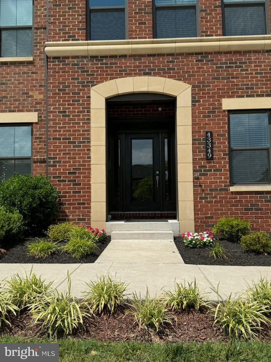 This gorgeous townhouse in the Westmoore community is 3,443 square feet of luxury and comfort thoughtfully arranged over four levels. From the premium lot to the interior upgrades, this house has those "extras" that set it apart. The home faces Westmoore Park and backs to a common area, so every view includes nature. The first level features a beautiful foyer with custom tile flooring, a convenient welcome center and half bath, and a bright, airy sitting room perfect for relaxing or entertaining. This level includes easy access to the 2-car garage which is equipped with an electric vehicle charger. 
The open floor plan places the kitchen at the heart of the main level--in the middle of an expansive living/dining/entertaining space. The kitchen itself includes upgraded granite countertops, a huge center island with room to seat 5, and ample storage. The stainless steel appliances, coordinating tile backsplash, and walk-in pantry create a beautiful work space while wood floors and soothing, custom paint colors create a serene gathering place. A balcony further extends the living/entertaining area to the outdoors.
The third level houses the master suite with two walk-in closets and its own luxurious bathroom with upgraded double sinks, full soaking tub, and frameless shower. Two more bedrooms on this level share a hall bath with double sink. The laundry room is conveniently located here as well. The fourth level contains an additional bedroom, full bath, and sitting area leading to a large rooftop terrace. 
The Westmoore community's amazing amenities include a pool, clubhouse, fitness center, amphitheater, dog park, numerous walking trails and tot lots, and two beautiful parks. The new Silver Line Metro is three minutes away by car, and access to the Toll Road is less than a mile away. This is a phenomenal home in a fantastic location!