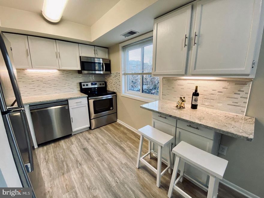 PARK IN SPACE E56. Gorgeous top floor condo featuring brand new wide-plank wood laminate flooring, fresh neutral paint throughout, and in-unit washer/dryer! Kitchen boasts stainless steel appliances, new granite countertops, new sink and faucet, high-end backsplash, and under cabinet lighting. Exceptional location just off 395 & Rt. 7, multiple bus routes, convenient to Shirlington Town Center, Pentagon City, Old Town Alexandria, and Downtown DC. Enjoy the amenities like outdoor pool, dog park, and the adjacent city park with picnic tables and grills! New Harris Teeter and Dining options open near the neighborhood. One reserved parking space. Water included in rental fee.  Tenant only responsible for electricity. Private storage room in the basement.