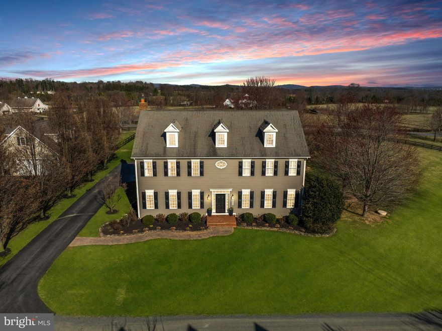 This  is an immaculate, must see, custom colonial home an exclusive premium .85 acre level lot in the desirable Waterfield Hamlet Community.  Enjoy the beautiful scenic vistas AND have access to high-speed XFINITY internet! Meticulously maintained 5000+ square foot beautifully updated home with 4 bedrooms, 4.5 bathrooms, a 2 story light filled foyer, inviting living room with built in bookcases, spacious dining area overlooking the back yard. Finished in place hardwood flooring on the whole main level, steps and upper hallway.   The eat in gourmet kitchen, which features quality cabinets, an island cooktop with exhaust fan, a French door refrigerator and a pantry.  All open to the big family room, making it the perfect family/entertaining space-especially with the masonry wood burning fireplace.  The main level also includes an office with French doors, and and amazing mudroom with hooks and storage bench seat, built-in cabinets for storage.  Upstairs you’ll find four really generously sized bedrooms, including a oversized primary suite and a newly remodeled spa bath. A grand spa soaking tub, frameless glass shower, granite double vanity with lighted mirror, update tile flooring, water closet and oversized closet. Two of the bedrooms share an adorable Jack and Jill bathroom and the other has a private bath with additional hallway access to the bath.  The beautifully finished lower level includes a bonus room for guests or a gym, a newer full bathroom. There is a big recreation room perfect for entertaining and a full bar with rustic cedar walls called " The Thirsty Dog Bar"  There is also a 700 sq ft unfinished area/ workshop space with double wide steps to the yard and double access doors making is easy to move large tools in and out of the basement area.  The back yard is the set up for perfect relaxation space. There is a private deck off the kitchen for morning coffee, a larger patio for entertaining and grilling out. The yard is very level and open with green space views all around and neighbors on only one side.   The Waterfield Hamlet is equestrian/animal friendly and encompasses over 150 acres of beautiful pastoral and wooded common areas, horse and walking trails, and a 6+ acre lake stocked with fish. Bring your chickens:)!Easy access to the HOA accessible side of the lake. Right next to the home is open space.  12 minutes to Purcellville and 5 minutes north to Lovettsville.  So close to town- you could bike in for your groceries or to restaurants, but not have to pay town taxes. Lovettsville community center features a pool, pickleball/tennis courts and offers various classes. There are many great restaurants- some of the best in Western Loudoun like: Market Table Bistro, 1836, Daughter Thai, Train to Mumbai, Andy’s Pizza and 2 Mexican restaurants. The list goes on regarding great restaurants nearby, as well as breweries, distilleries, and wineries. There is even a winery that you can walk to! You’ll also be a 10-minute drive to the Potomac River! Don’t miss this house- it is a true gem- with so many updates!