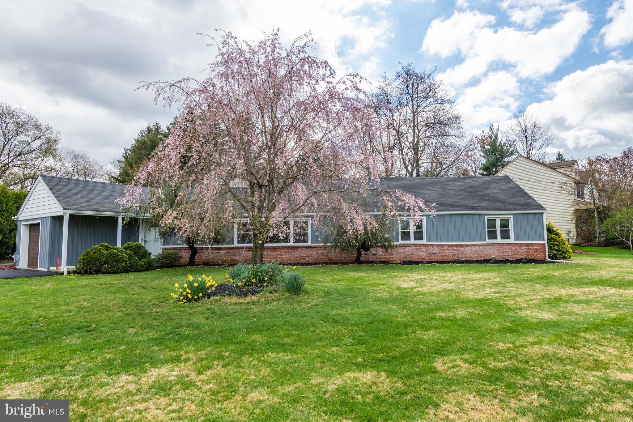 Welcome to 1101 Lansdale Avenue in Montgomery Township. This meticulous, rambler home has been completely transformed. The dark wood facing of the past has been updated to a bright, modern day with new vinyl siding and brick face.  Many of the windows were replaced in 2018. The house is set on .73 acres with a brand-new asphalt driveway leading up to the 1 car garage. Plenty of space for family and guest parking. As you enter the home you will walk into the living room and your eye will be drawn to the focal point of the room – the newly refaced, fireplace that has an electric insert but can still burn wood. The living, dining room and hall were freshly painted plus vinyl flooring was installed in 2022.  The kitchen was updated in 2019 with stainless steel appliances, gas range/oven, tile flooring and high-end granite countertops.  Beyond the dining room you will find 2 spacious main level bedrooms with hardwood floors and ceiling fans.  The laundry with a new washer and dryer is on the main level.  The third bedroom can be found on the second level with hardwood floors.  For your enjoyment the concrete patio is very spacious and covered plus a ceiling fan for warmer seasons.  The stone extension to the patio is a perfect spot for a fire pit.  The fence was installed in 2016 and surrounds a very spacious back yard. Major roadways will take you in every direction that can be accessed locally. Close to shopping, restaurants, public transportation, schools, and parks. If you are looking for an amazing home with everything you need within an arm’s reach, you have found the one! Make an appointment today as this home will not last long!