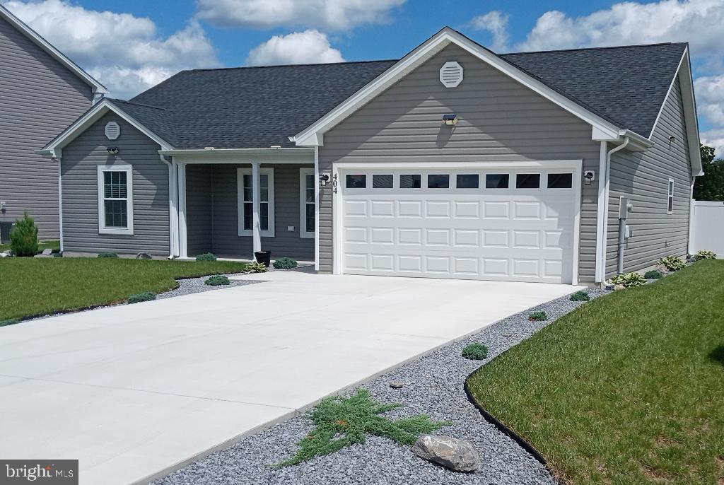 Enjoy easy one level living in this two year young spacious ranch home with many upgrades beyond standard feature list. Featuring open concept living with cathedral ceilings and recessed LED lighting throughout. Large master bedroom with tray ceiling, recessed lights and ceiling fan, walk in closet and attached primary en suite bath with ceramic flooring, oversized seated tiled shower with glass doors and Bluetooth fan/speaker/LED combo. Kitchen features an oversized island, extended length solid granite counter tops, stainless appliances, soft close cabinets. Upgraded glass panel entry door allow enhanced natural lighting and the neutral color scheme, LVT flooring throughout, custom stonework on the kitchen island and entry areas tie everything together beautifully. The second bath features custom fit glass shower doors and tile flooring as well. Slider access from the kitchen leads out to a huge oversized 20 X 20 patio area. Low maintenance custom year round stone landscaping makes upkeep a breeze and features a full fenced back yard and patio area with 6’ no maintenance vinyl privacy fence with dual gate access. The two car garage comes with upgraded RaceDeck custom flooring and is fully dry-walled & insulated with garage door and openers. Full home alarm system, upgraded generator hook up, exterior motion solar security lighting, all custom fit interior window dressings, all appliances and upgraded Whirlpool washer and dryer combo are also included. This non smoking turnkey home needs nothing and has been immaculately maintained and cared for.