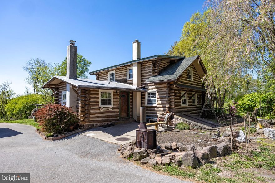 Picked right out of a fairytale story book, this magical log cabin will enchant you.  This unique and quant property offers an expansive lot with just under two full acres. The charm of this home is unmatched by any other property on the market today! The main level of the property boasts a convenient bedroom for anyone who needs one level living. The kitchen is bright and airy with electric cooking and recessed lighting. The living room has gorgeous, wide length wood flooring and a wood burning fireplace to keep you cozy on a chilly winter day.  The main level comes complete with a full bath and a carpeted sunroom for additional living space. The upper floor has two nicely sized bedrooms, large enough to easily fit king-sized beds and much more! Travel into the basement area and be shocked by the 9ft plus tall ceiling height. Tree trunk joists and a stone foundation make the basement into a really neat space. This area could be easily finished for additional living space. Recent upgrades include: Mostly newer windows throughout, new hot water heater as of 2021, new well pressure tank in 2019, 200amp panel, newer HVAC system, and newer roof! 
Outside the sunroom area is a lovely, covered patio, perfect for entertaining or enjoying the day. This home is truly unique as there has been a zoning acceptance for 1 horse to reside on the property. There are two fenced corrals for your hooved friend and two stable areas where they can lay their head down in hay. The exterior buildings offer so much additional storage, parking, and workshop potential to the next owners! The detached garage offers over 900 square feet of additional space for all your creative ideas. There is also a semi-finished loft area above the driveway facing garage that would be perfect for an art studio! Do not miss the opportunity to tour this amazing, one-of-a-kind home before it's gone! THIS HOME IS ON PUBLIC SEWER, NOT SEPTIC!!!
