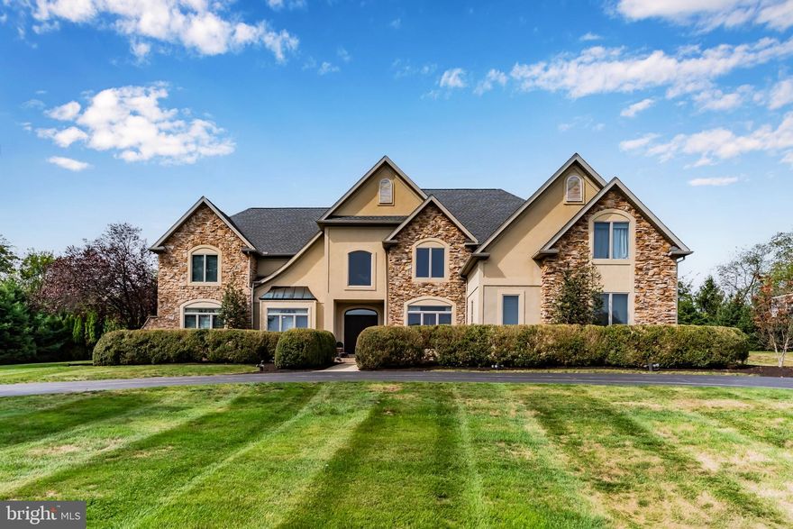 Welcome to 4216 Prosperous Drive — a stunning custom-built residence offering over 7,000 square feet of exquisitely finished living space in Central Dauphin School District. This impressive 6-bedroom, 5 full and 2 half-bath home blends luxury, functionality, and exceptional design for modern living.  The first floor showcases a chef’s dream kitchen with premium stainless steel appliances, four dishwasher drawers, dual Monogram refrigerator/freezer, a six-burner gas range with vent hood, and an expansive breakfast bar. The kitchen seamlessly opens into a grand dining area with vaulted ceilings and a built-in bar, creating the perfect atmosphere for entertaining. Relax in the inviting living room complete with a gas fireplace and soaring ceiling, or retreat to the formal living room for more intimate gatherings. A private office, home gym with half bath, mudroom with built-ins, and an additional half bath complete the main level.  Upstairs, the primary suite offers a spacious sitting area with gas fireplace, dual walk-in closets, and a luxurious en suite bath with double vanities. The 2nd bedroom includes its own private bath, while bedrooms 3 and 4 share a Jack and Jill design. A convenient laundry room is also on this level. A separate upper wing provides two additional bedrooms joined by another Jack and Jill bath—ideal for guests or extended stays.  The lower level is an entertainer’s paradise, featuring a spacious den with kitchenette, full bathroom, and even an indoor basketball court. Ample unfinished space provides storage options and bilco walk-out access.  The exterior boasts a large patio with pergola and hot tub, perfect for relaxing evenings outdoors. The semi-circular driveway offers easy access, and the oversized three-car garage includes built-in cabinetry for organized storage. Major updates include a new roof in 2024.  With unmatched space, thoughtful amenities, and premier location, this exceptional property delivers both comfort and sophistication — the perfect home for entertaining and everyday living, schedule your private tour today!