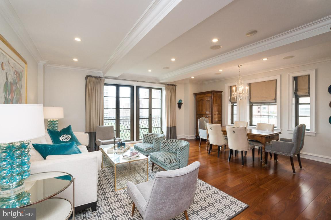 Sun soaked two bedroom, two bathroom at the highly coveted Parc Rittenhouse with the unique distinction of being one of only a few homes with all rooms overlooking Rittenhouse Square. Enter the home through a foyer into a large, corner great room bathed in natural light with generous living and dining space and a Juliet balcony that literally brings the Square into the home. The adjacent, open kitchen boasts wood cabinetry with stainless steel bar pulls, granite countertops, a tile floor, Sub-Zero stainless steel refrigerator/freezer and a recently replaced Viking stainless steel oven, stove, dishwasher and microwave. The sumptuous primary bedroom has two custom fit-out walk-in closets, a wallpapered accent wall and an ensuite bathroom with floor-to-ceiling marble detail featuring a double vanity and oversized walk-in shower. The second bedroom has a custom fit-out wall closet and enjoys use of the full hall bathroom that is also appointed in marble and houses the washer and dryer. There are Brazilian cherry hardwood floors; crown, baseboard and ceiling moldings; custom window treatments; and recessed lighting and custom paint throughout. One parking spot and one storage space available for sale. Residents of Parc Rittenhouse enjoy a 24-hour doorman/concierge, state-of-the-art fitness center, clubroom and boardroom and a seventh-floor rooftop club featuring an outdoor pool, whirlpool spa, kiddy pool and sundeck with lounge chairs.