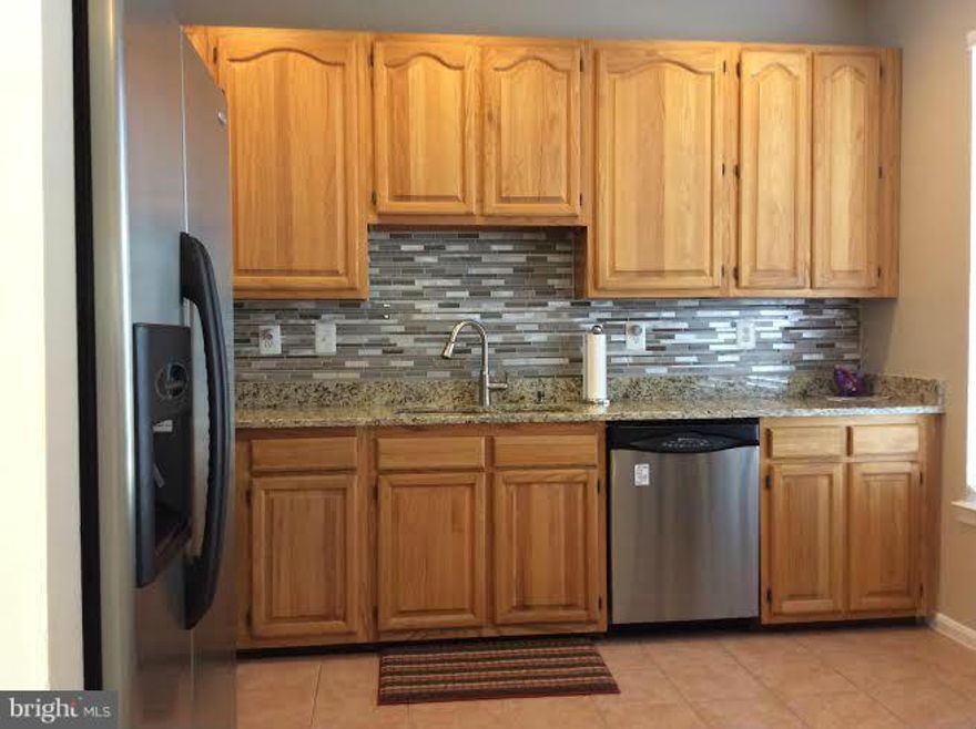 Beautifully updated 3 level home features gorgeous eat-in kitchen w/ granite counters and tile backsplash, stainless steel appliances & large pantry. Sun filled main level living and dining rooms have open floor plan, LL has family room, 4th bedroom, full bath, laundry & tons of storage. Commuter's dream: close to major hwys, schools, shopping, restaurants & more! Available 9/1/15