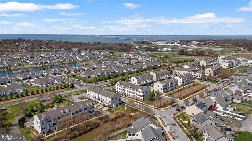 Meticulously maintained by the original owners, this beautifully UPGRADED End-unit Townhome offers 3 finished levels totaling 2300sqft, a 2-car garage, and Rarely found DUAL Primary Suites—each featuring a spa-inspired bath with soaking tub, separate shower, ceramic tile floors & surrounds, and expansive walk-in closets. The entry level features hardwood floors, a spacious living room, private office/flex space, and powder room. Venture up the Oak hardwood staircase to the Open-concept main level, showcasing gleaming hardwood floors in the Great room with corner fireplace that flows seamlessly into the Gourmet kitchen. Highlights include: 42” maple glazed cabinets with soft-close doors and drawers, under and over cabinet lighting, Granite countertops, Stainless steel appliances, Double wall ovens, Gas cooktop, 12x12 Ceramic Tile floors, Lighted pantry, Upgraded Trim package, plus a two-tier island with seating and a separate dining area. Step outside to the 12x20 Trex deck complete w/ propane line for your Grill & outdoor speakers making it perfect for entertaining on these upcoming Summer nights! The upper level features dual primary suites, including a front bedroom with vaulted ceiling and exceptional space throughout & Full size Laundry room w/ Front loading washer/dryer. Additional features include: Brand NEW Roof, central vacuum, whole-house audio throughout main living areas, bedrooms & deck, whole-house humidifier, ceiling fans, brushed nickel fixtures, utility sink rough-ins (laundry and garage), custom garage shelving, and kayak storage under the deck. Thoughtfully landscaped perennial gardens provide color year after year and is just another example of the love that was poured into designing this home! Enjoy an amenity-rich community with pool, clubhouse, and floating dock/pier with access to Thompson Creek. Ideally located just minutes to the Chesapeake Bay Bridge for an easy commute and convenient access on and off the Shore. Check out the 3D iGuide Tour!