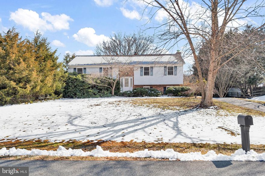 Come and see this lovely 3 bedroom, 2 full bath brick home in this popular community.   The long driveway goes behind this home with access to the two-car garage with opener.   As you enter the foyer, you will see the updated front door, new light and closet.  The large Living Room and Dining Room both have hardwood flooring and two bay windows.  The eat-in Kitchen has double stainless steel sinks, two lighted cabinets, refrigerator, dishwasher, disposal and electric range all included.  The three bedrooms are spacious with great closet space and hardwood floors.  The Main Bedroom Suite has two double closets, private full bathroom with double sinks and double shower.  There is a convenient hall linen closet and another full bathroom on this level.  The lower level has a huge Family Room with a floor to ceiling brick fireplace and raised hearth.  This room can be easily divided into two rooms, Recreation Room, Media Room and Exercise area.  You can do your laundry while watching tv in this great room area.    This home has custom windows, and the attic access has been updated with an upgraded pull-down ladder.  This location is awesome in that you are close to everything!