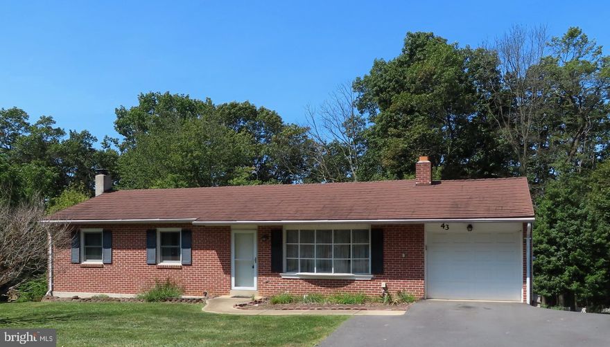 Rancher with 3 bedrooms, 1 1/2 baths with city water/sewer, large living room, kitchen & dining combo, walk out door to 12' x 17' covered deck overlooking the rear yard and wooded area behind the yard.  The kitchen has Oak cabinets with window overlooking the rear yard.  The lower level has a 24' x 24' finished family room with 1/2 bath and walk out level to rear yard.  The home has a flue with a "Sierra" wood burning stove.  The home has thermo pane tilt in windows, anti-theft catches, and screens and upgraded fiberglass insulated door in 2022.  The home has a lifetime metal roof,  a 200 amp Cutler Hammer circuit breaker box, a high quality storm door at entrance level.  There is a 11'6" x 21 full room under the garage with walk out rear access perfect for storage or a workshop.  Storage area above garage is floored and has a pull-down stairs.  This was the 1st house built in the development and is a second owner home.  Included with the house:  Refrigerator, electric oven/range, portable dishwasher, electric dryer, washer and nice picnic table on rear covered deck.