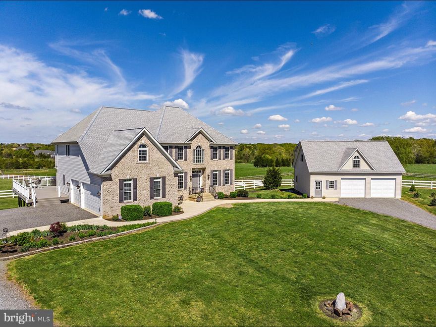 Wonderful country house with lovely views.  Hardwood on both levels, fully finished basement, front and rear staircases, garaging for 4-5 cars, covered riding ring, 8 stall center aisle stable, watered paddocks, well fenced, generator, much more to come.  Please no drive-ins,  pet/security system/Comcast.  Many newer components, peaches, raspberries, blueberries, bridle paths.  All inspections to be performed by Buyer's Agent.