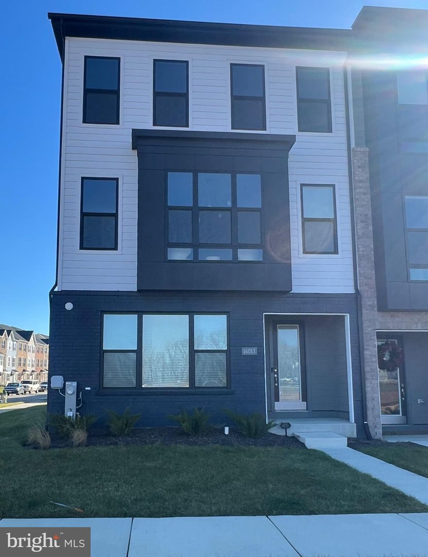 This is a rare opportunity to own a beautifully upgraded 2025 end unit townhome in South Lake, Bowie’s most exciting new community. From the moment you enter, this home delivers a level of style, comfort, and modern living that stands out.

The entry level features a true multi generational suite complete with a full bath and a spacious recreation room, offering exceptional flexibility for guests, in laws, or long term stays. The two car rear load garage and covered front entry add convenience and curb appeal.

The main level is designed for entertaining and everyday luxury. Enjoy an open concept gourmet kitchen with an extended island, a bright dining area, and an upgraded family room enhanced by a custom entertainment wall. This home includes upgraded recessed lighting throughout the main level and a beautifully crafted dry bar that elevates the space for hosting. It is also pre wired for whole home audio and a full in home theatre setup, allowing effortless integration of high end entertainment. A fully upgraded powder room completes this level with extra comfort for guests, while the private study with pocket doors offers the ideal work space. Just beyond the family room, the covered rear terrace provides a comfortable outdoor retreat.

Upstairs, the primary suite feels like a private sanctuary with dual walk in closets, an elegant tray ceiling, and a spa inspired bath featuring a freestanding soaking tub and an oversized walk in shower. The primary suite is also pre wired for an in home theatre setup, creating the perfect space for a personal cinema experience. Two additional bedrooms and a full bath complete the upper level.

South Lake is known for its resort style amenities which include a beautiful clubhouse with fitness center and lounges, a resort pool with children’s splash pad, two dog parks, fitness trails with outdoor stations, several playgrounds, pocket parks, open play fields, access to Liberty Sports Park, walkable proximity to the new South Lake Marketplace, and within miles of the Bowie Town Center.

Located between Washington DC and Baltimore, this home offers convenient access to Route 50, Route 214, Route 301, the Largo Metro, Fort Meade, Joint Base Andrews, and major commuter routes. Everything about this home and community creates an exceptional living experience.

This is a move in ready opportunity you will not want to miss in South Lake, Bowie’s premier new address.