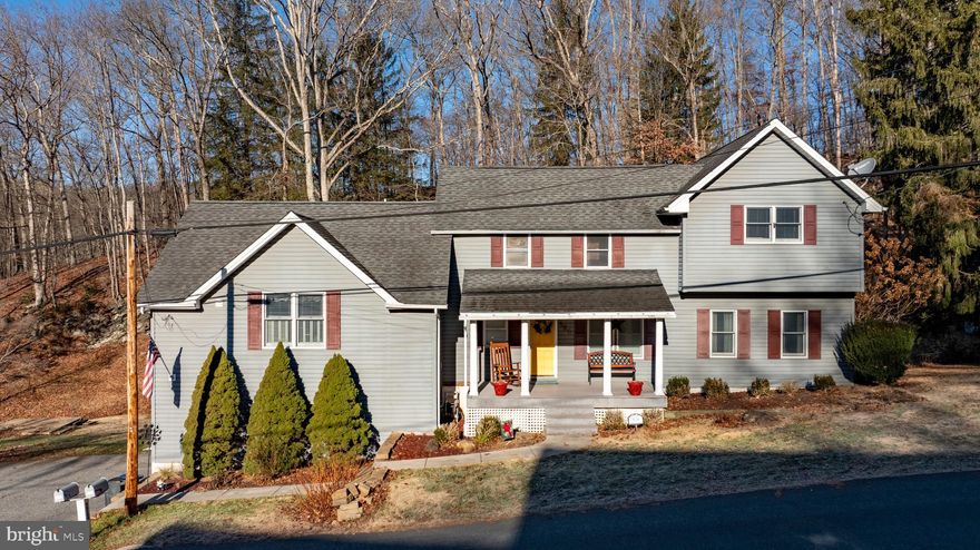 Come fall in love with this charming circa-1890 Parkton home set on 5+ scenic acres just moments from the NCR/Torrey Brown Rail Trail.  Multiple decks overlook Bentley Springs stream and beautiful natural surroundings.  The spacious eat-in kitchen features silestone countertops, a center island, gas cooktop and stainless steel appliances.  The inviting family room showcases vaulted ceilings with rustic beams and a cozy pellet stove.
The property includes a two-car attached garage, plus a one-car detached garage that formerly served as the mechanic shop at the New Freedom train station and was relocated to the property.  An additional outbuilding offers flexible space for storage, hobbies or a poultry house.  Recent improvements include a replaced BAT septic system, renovated bath w/heated flooring, blending historic charm with modern comfort.   Overhead drone photos show back property line in relation to BeeTree Run and NCR trail.  Bentley Springs NCR parking lot just down the road. Don't delay, take a look today!