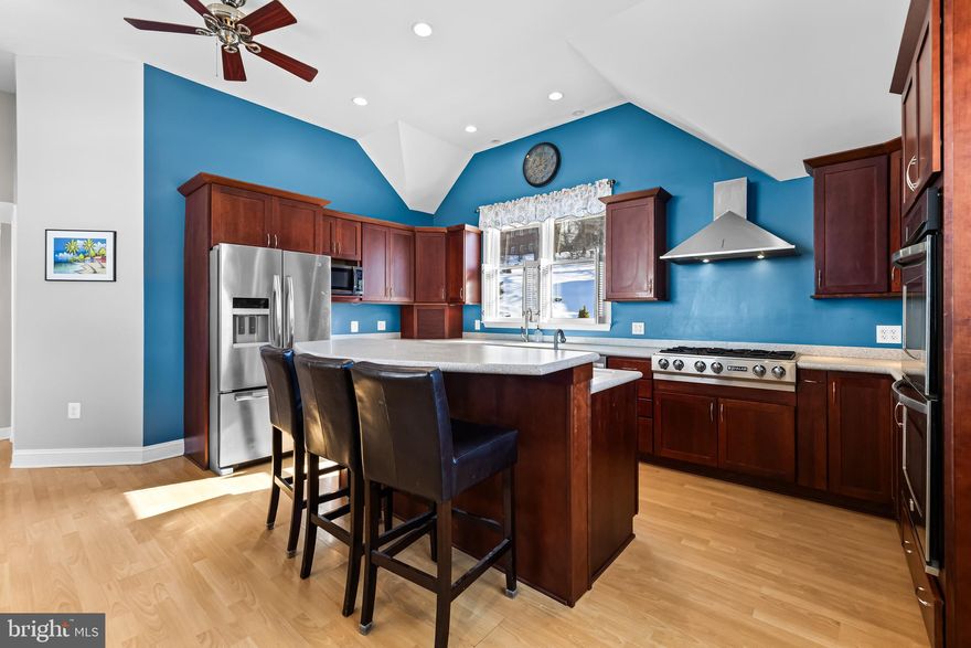 Come fall in love with this charming circa-1890 Parkton home set on 5+ scenic acres just moments from the NCR/Torrey Brown Rail Trail.  Multiple decks overlook Bentley Springs stream and beautiful natural surroundings.  The spacious eat-in kitchen features silestone countertops, a center island, gas cooktop and stainless steel appliances.  The inviting family room showcases vaulted ceilings with rustic beams and a cozy pellet stove.
The property includes a two-car attached garage, plus a one-car detached garage that formerly served as the mechanic shop at the New Freedom train station and was relocated to the property.  An additional outbuilding offers flexible space for storage, hobbies or a poultry house.  Recent improvements include a replaced BAT septic system, renovated bath w/heated flooring, blending historic charm with modern comfort.   Overhead drone photos show back property line in relation to BeeTree Run and NCR trail.  Bentley Springs NCR parking lot just down the road. Don't delay, take a look today!