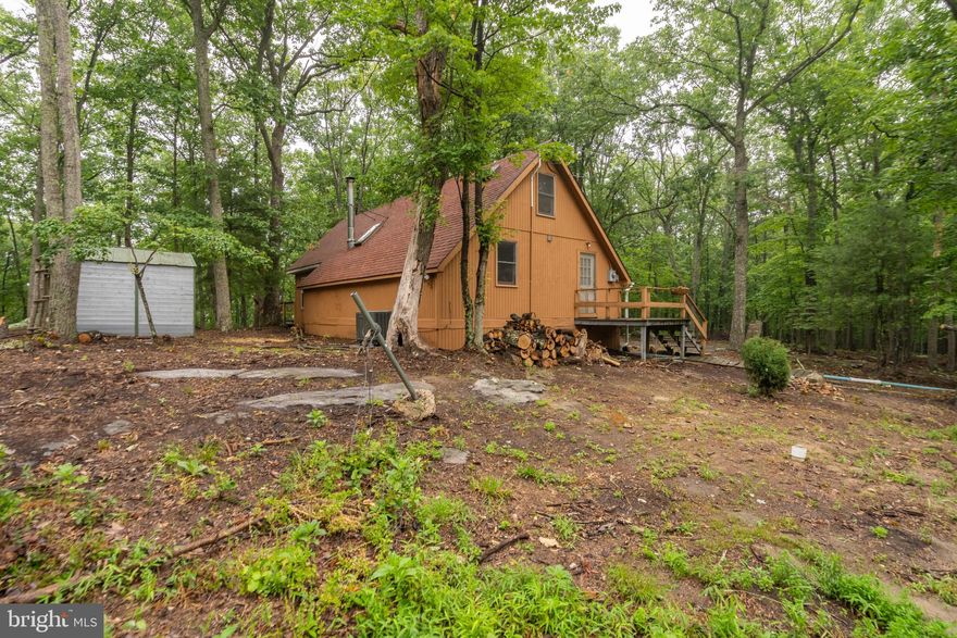 This home is cozy!!! Perfect full-time or weekend living. Can also be used as a profitable Airbnb as well. This cabin in the woods sits on 5 beautiful and gentle slopping acres. Lots of updates have been done inside. Kitchen is bright and sunny with all the modern amenities and walks out to the back deck for easy grilling and entertaining. Cathedral ceilings, a wood stove and skylights are in the family room. A spiral staircase leads you to a loft that can be used as a second bedroom. Owners bedroom is on the main level along with a renovated bathroom and full size washer and dryer. The community beach with sand is the perfect place for summer swimming and there is a stocked pond to fish. There is also a park and tennis courts. This community is 4-wheeler friendly so you can enjoy a ride through the mountains. Hunting is allowed as well. This is a must see!!